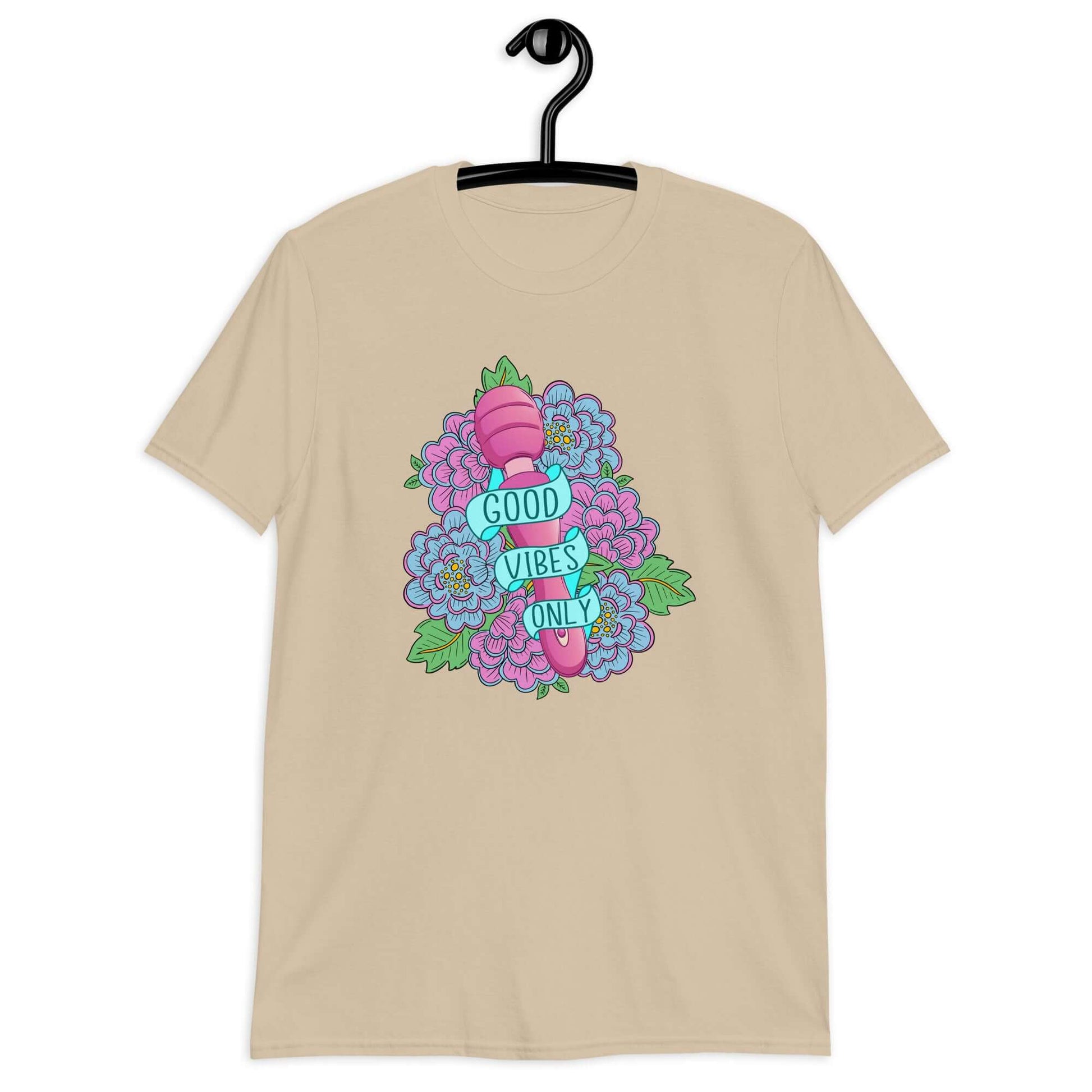 Sand t-shirt with graphic design that has the words Good vibes only layered over a pink wand vibrator with flowers around. The graphic design is printed on the front of the shirt.