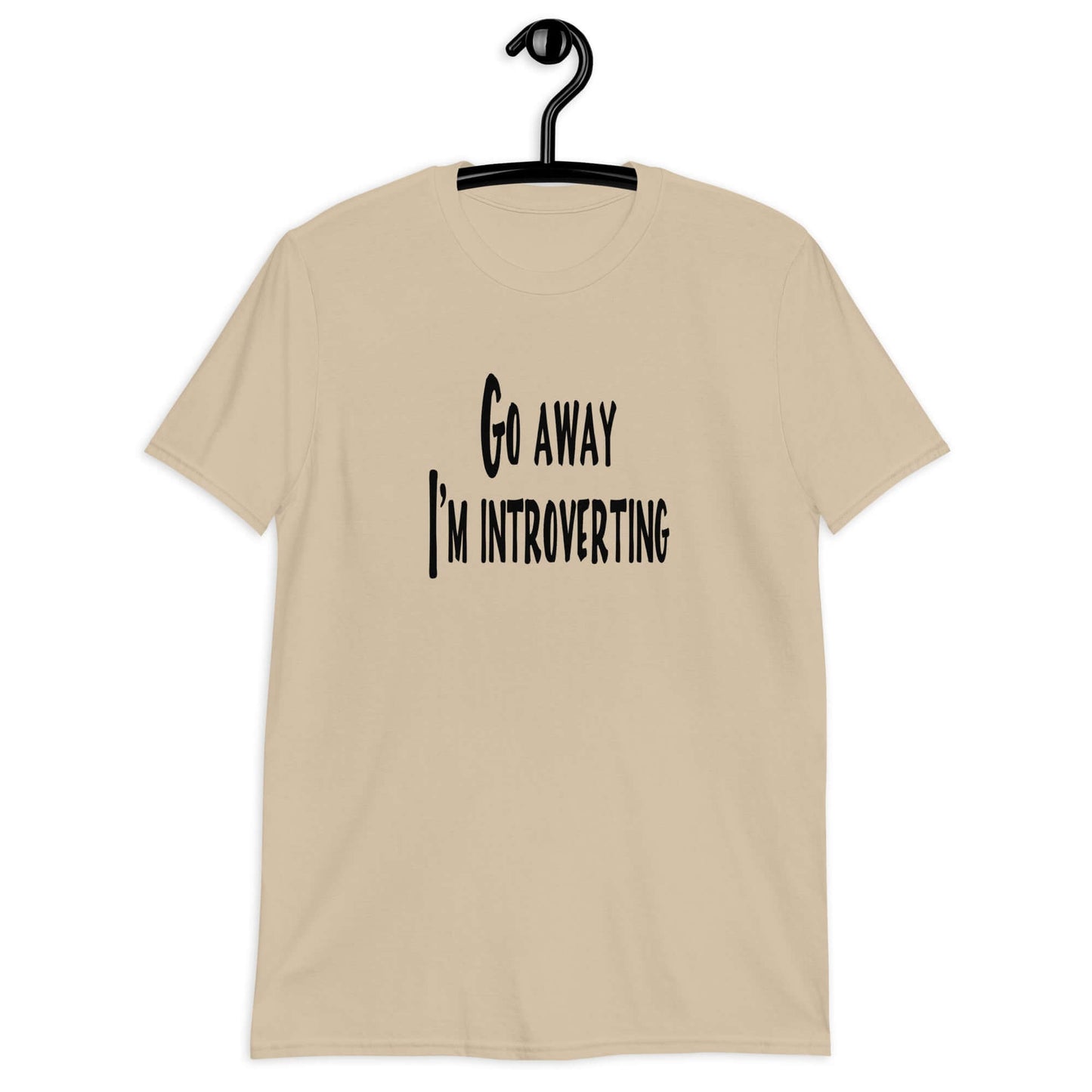 Sand t-shirt with the phrase Go away, I'm introverting printed on the front of the shirt.