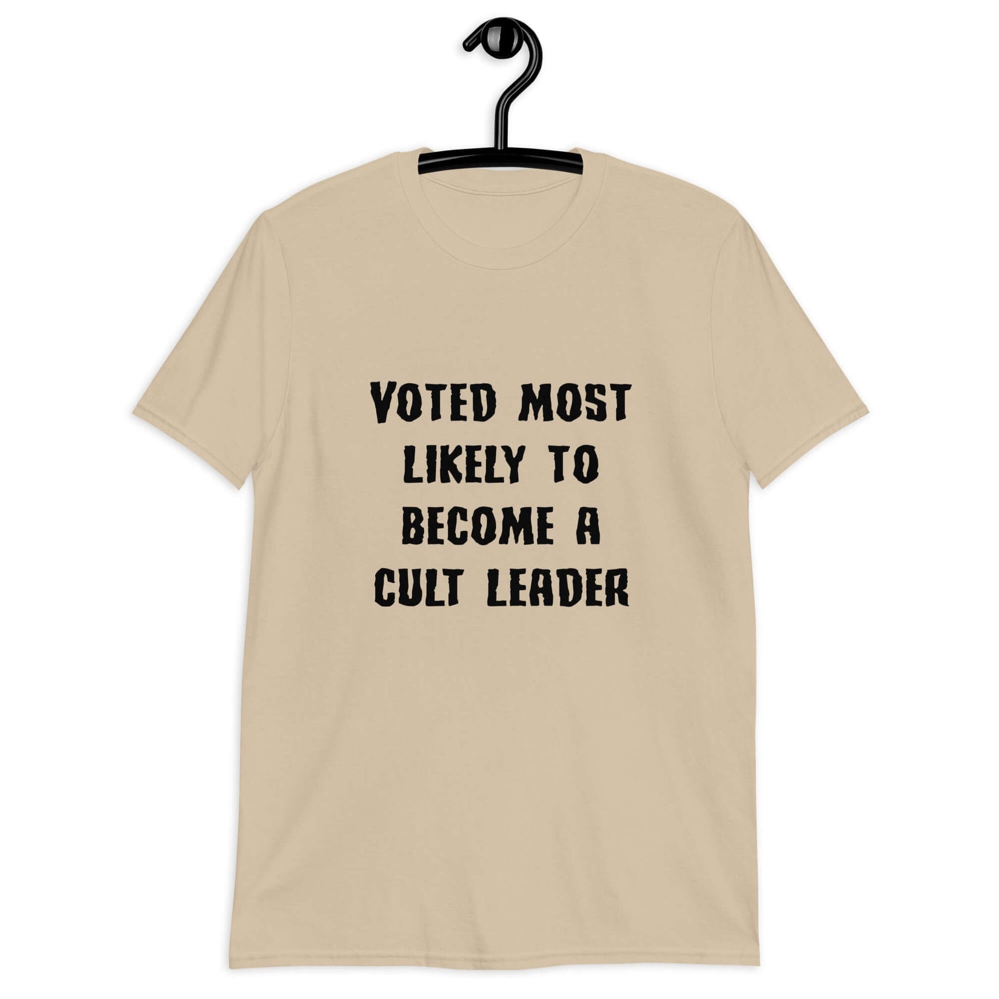 Sand color t-shirt with the phrase Voted most likely to become a cult leader printed on the front.