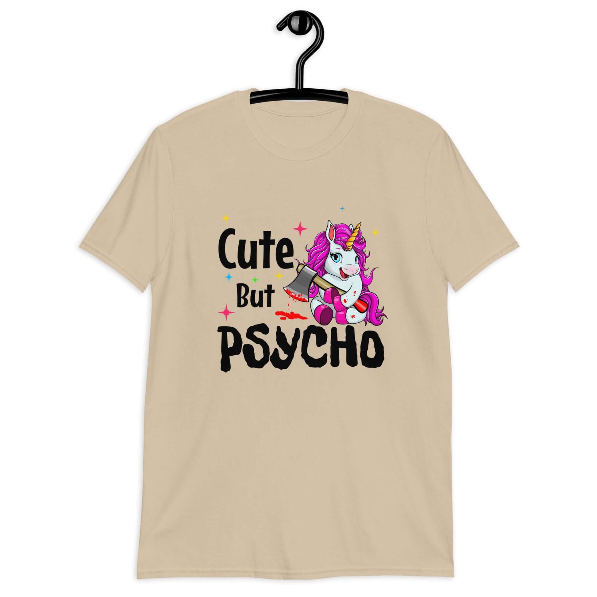 Sand t-shirt that has a graphic of a unicorn holding a knife & the words Cute but psycho printed on the front.