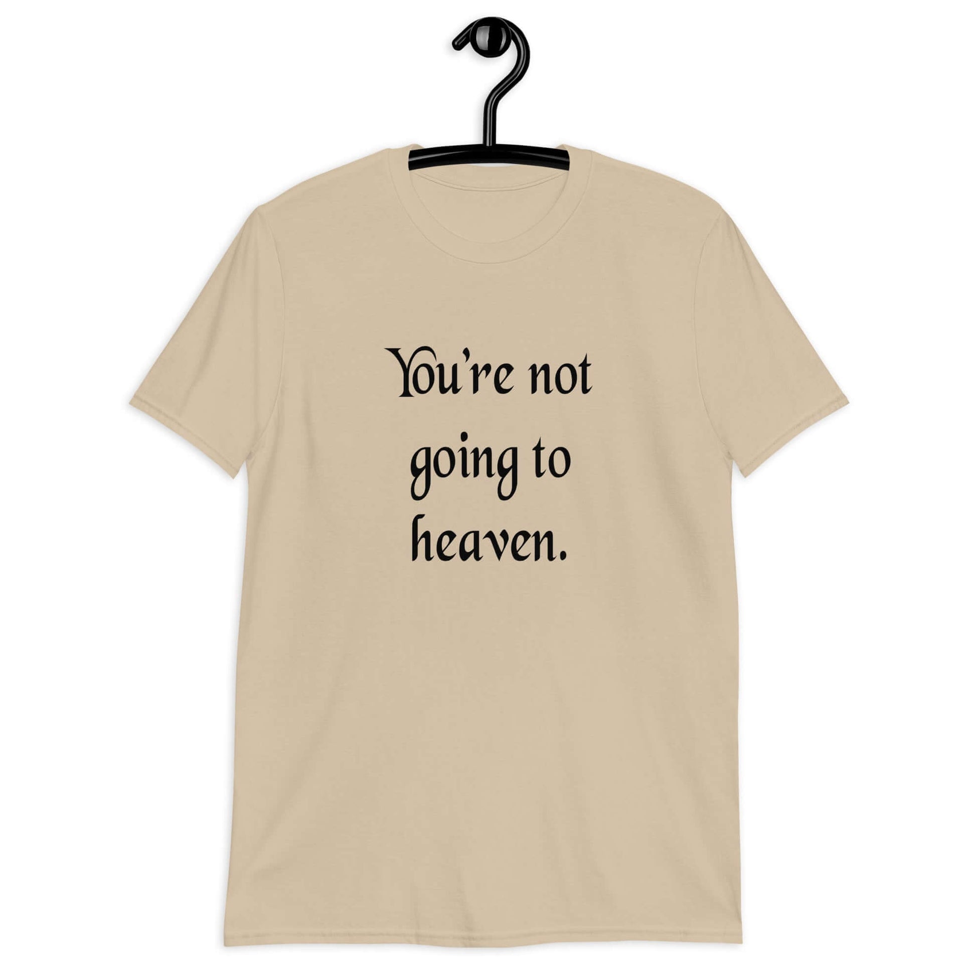 Sand t-shirt with the phrase You're not going to heaven printed on the front.