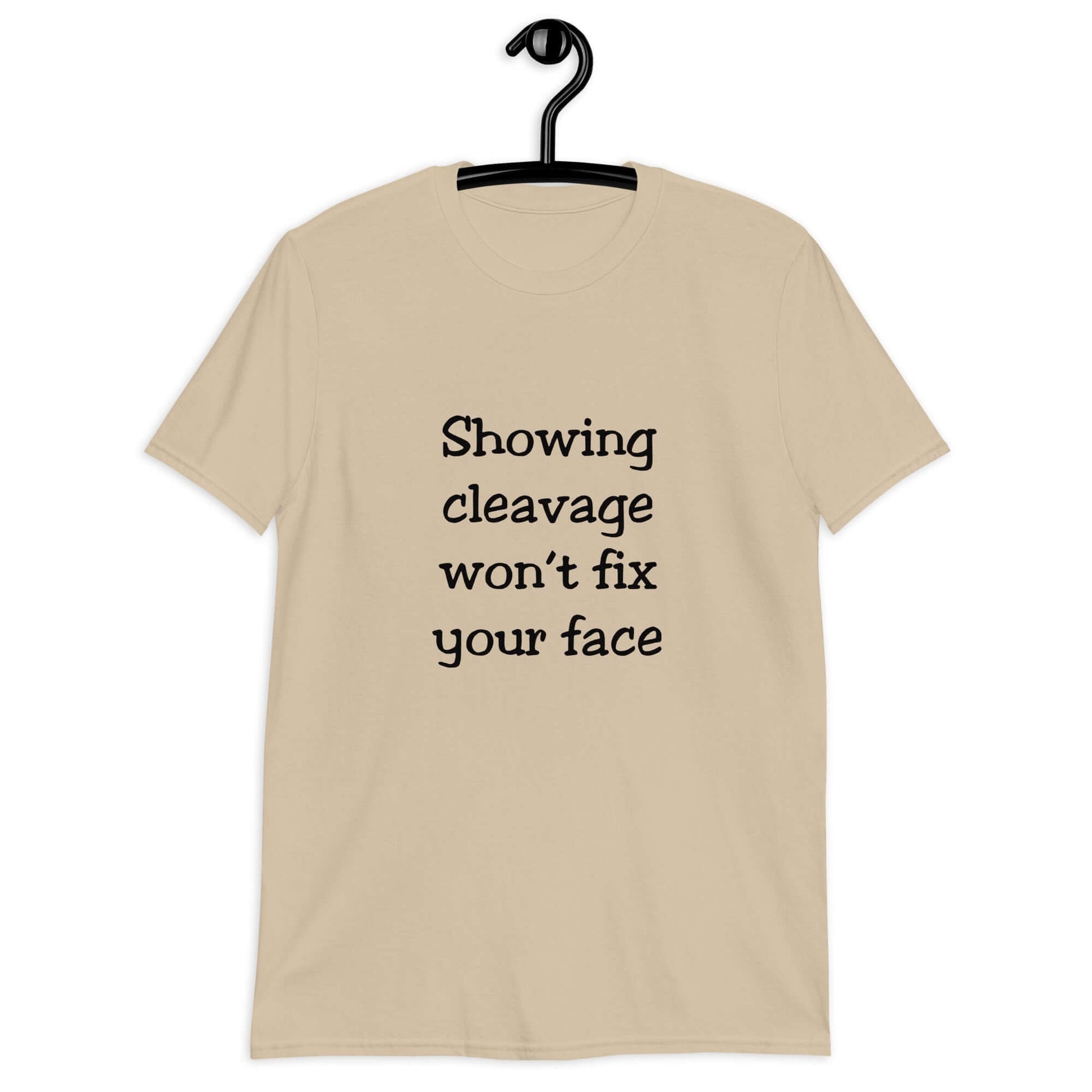 Sand color t-shirt with the phrase Showing cleavage won't fix your face printed on the front.