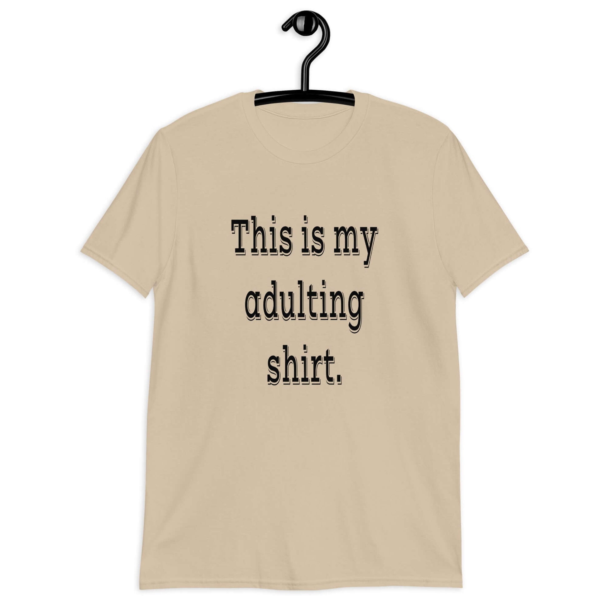 Sand color t-shirt with the phrase This is my adulting shirt printed on the front.