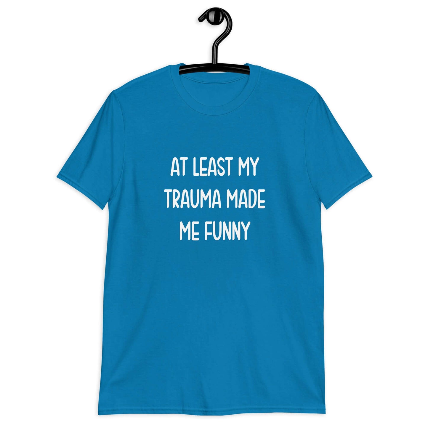 Sapphire blue t-shirt with the words At least my trauma made me funny printed on the front.