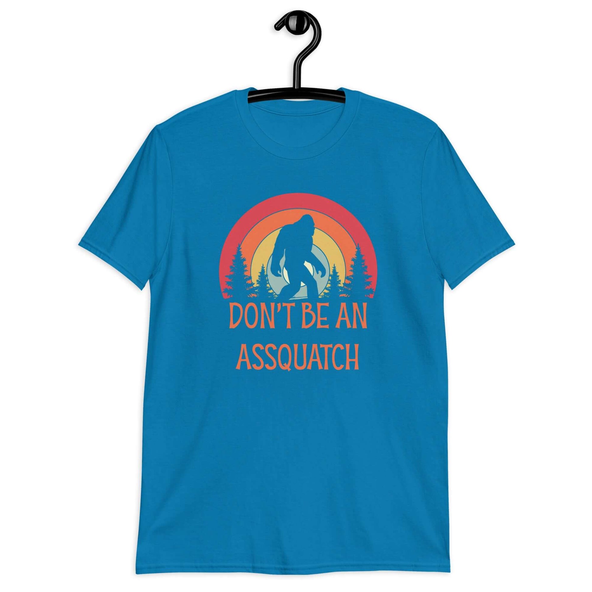 Sapphire blue t-shirt with sasquatch graphic and the words don't be an assquatch printed on the front.