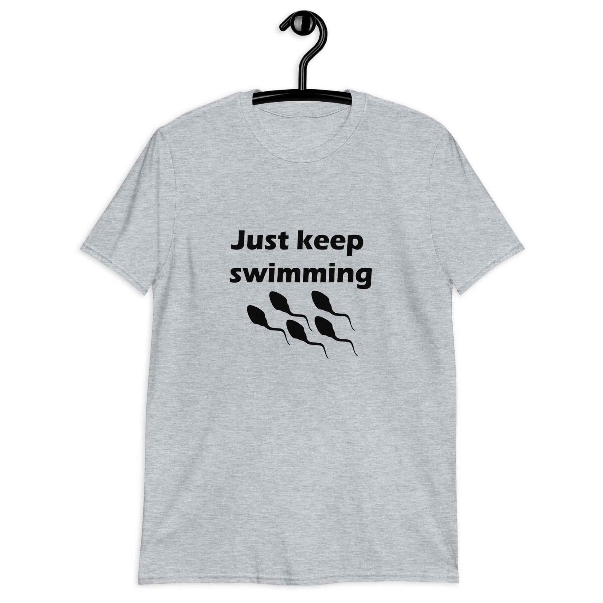 Sport grey t-shirt with the phrase Just keep swimming printed on the front. There is an image of some swimming sperm underneath the words.