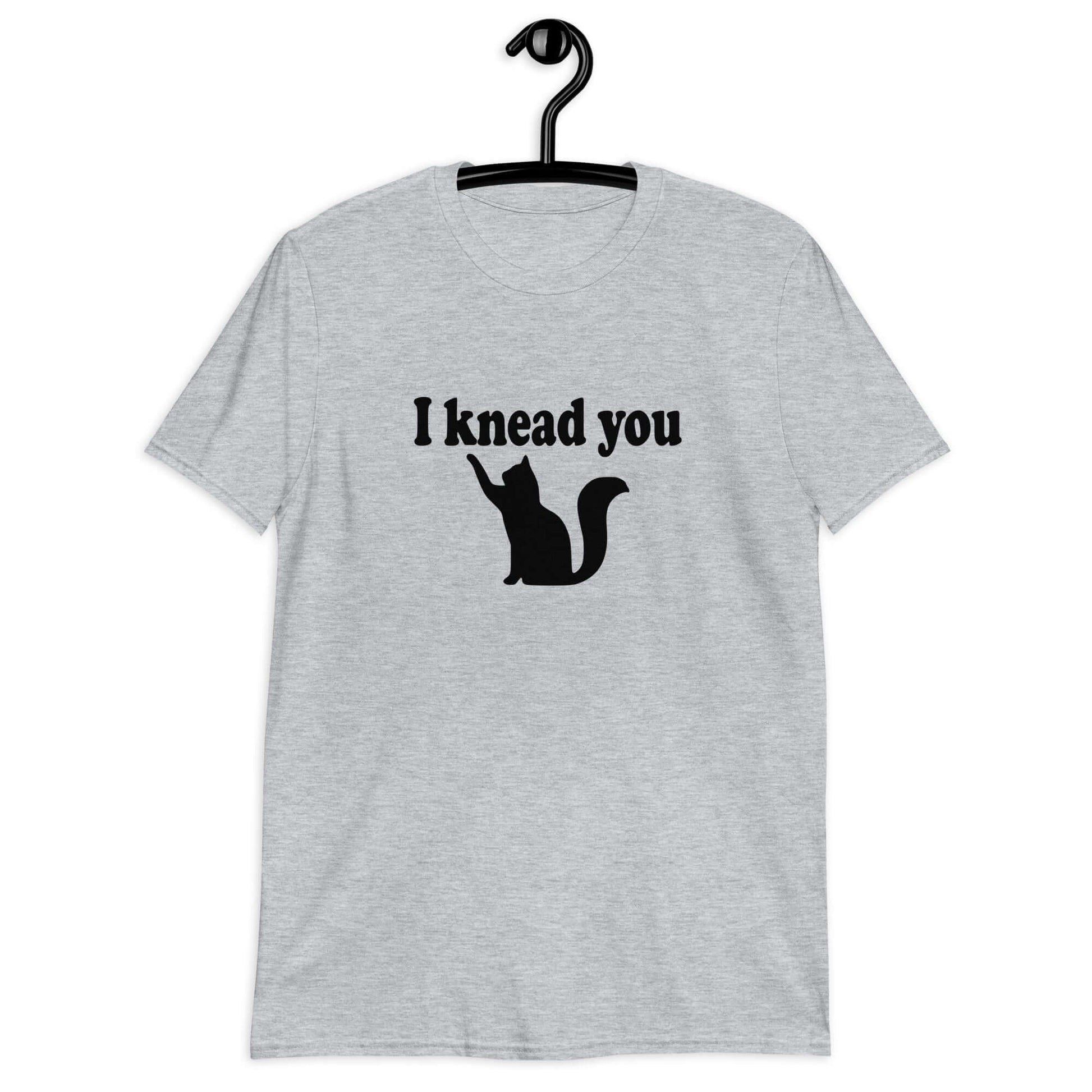 Sport grey t-shirt that has an image of a silhouette of a cat and the words I knead you printed on the front.