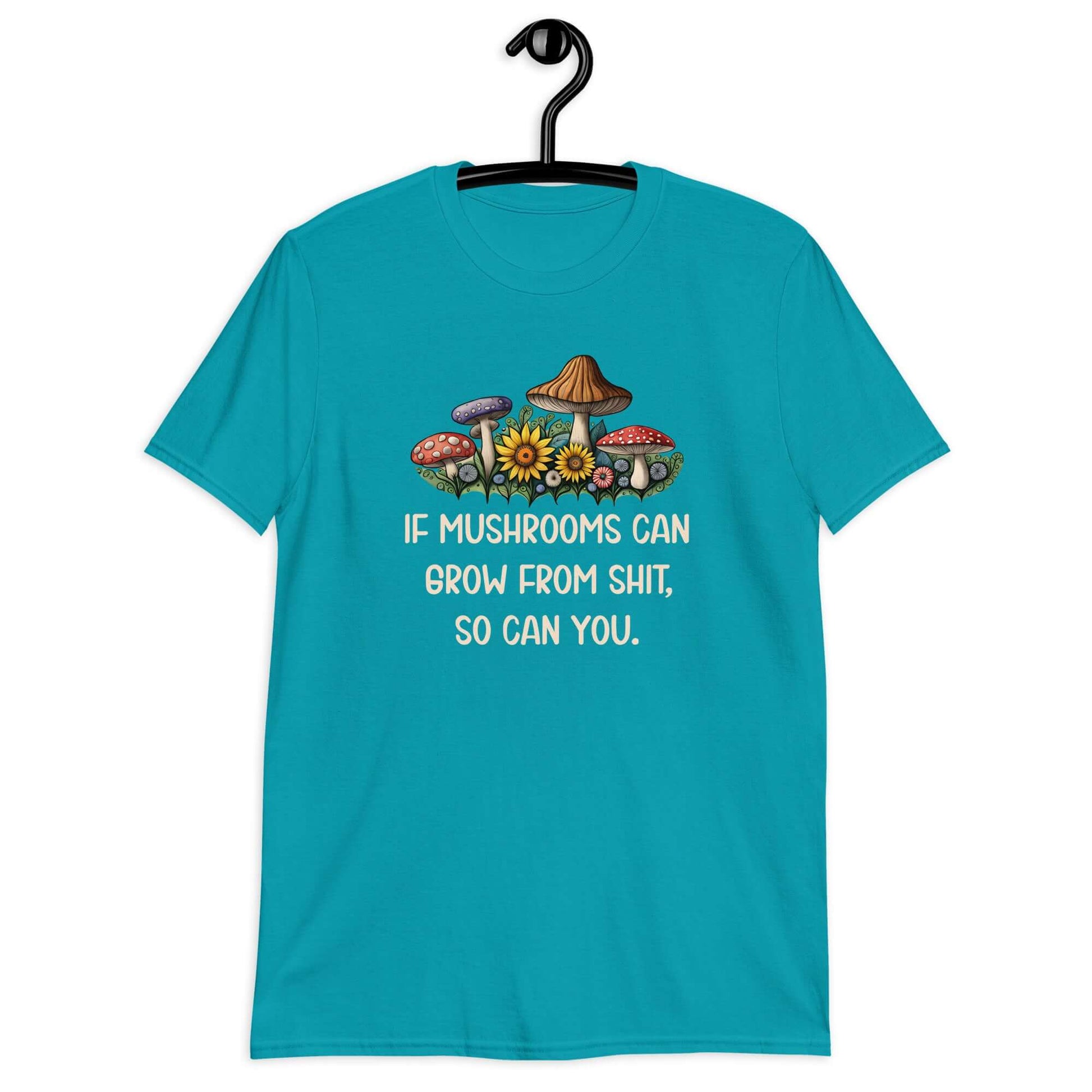 Tropical blue t-shirt with images of mushrooms and the phrase If mushrooms can grow from shit so can you printed on the front.