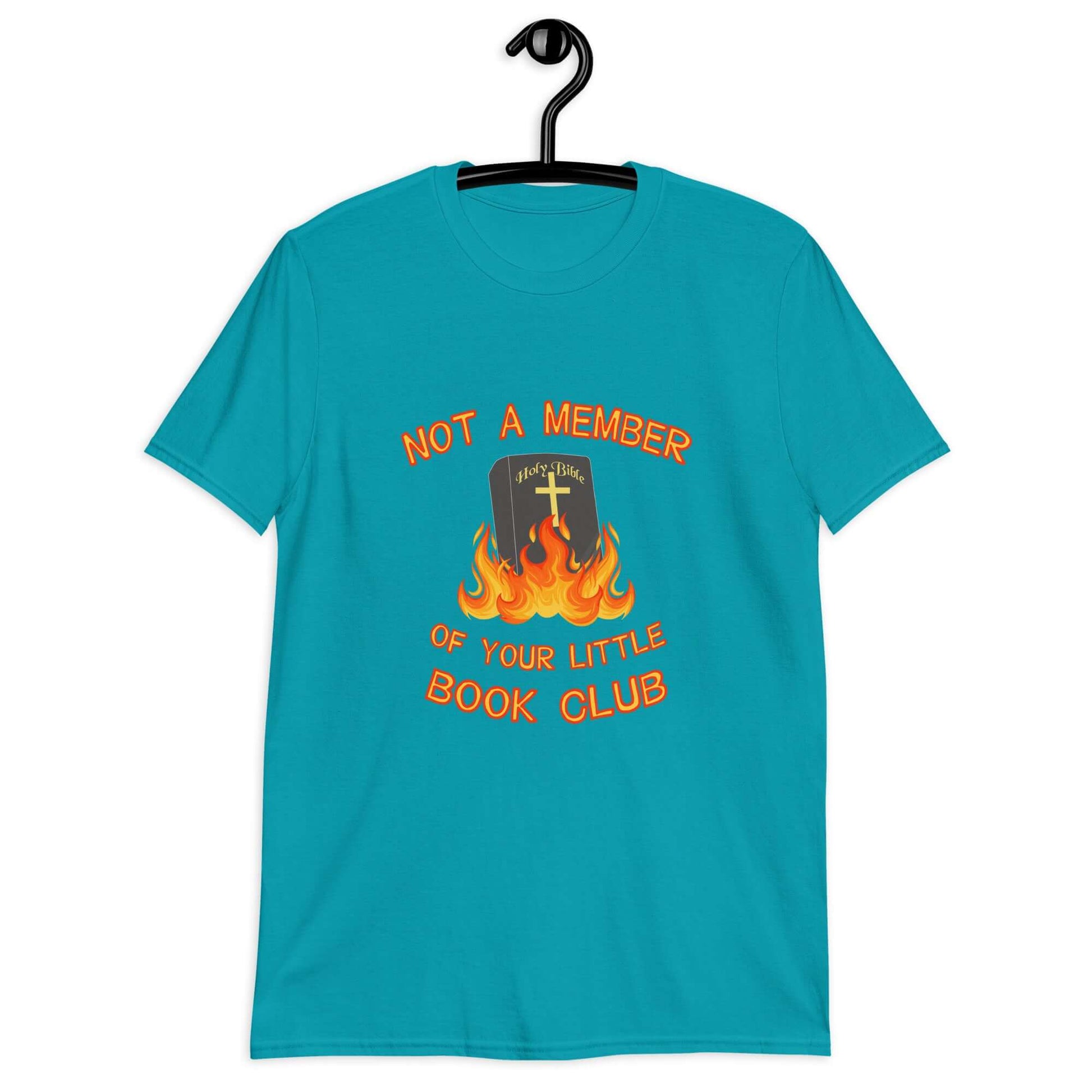 Tropical blue t-shirt with image of a burning bible and the words Not a member of your little book club printed on the front.