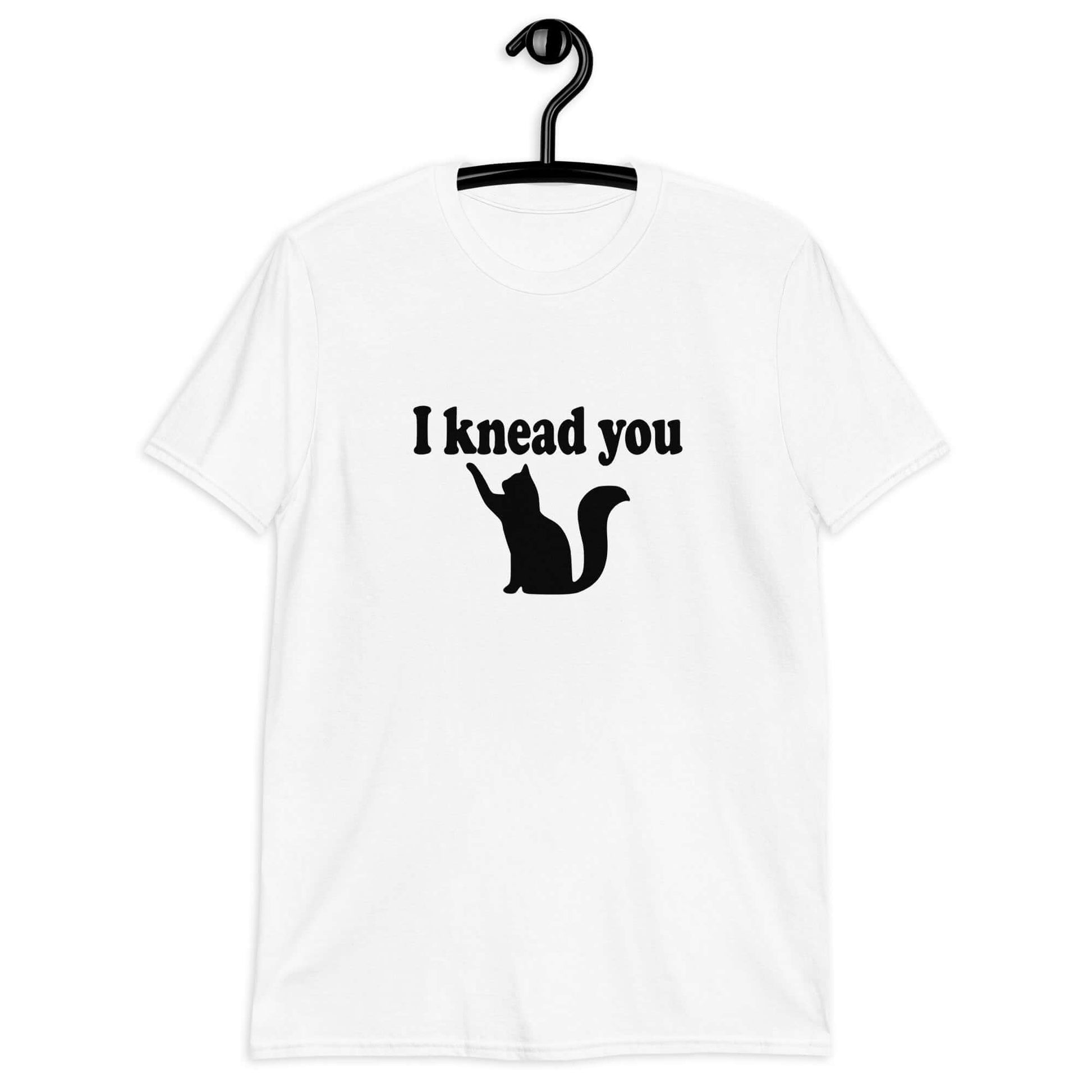 White t-shirt that has an image of a silhouette of a cat and the words I knead you printed on the front.
