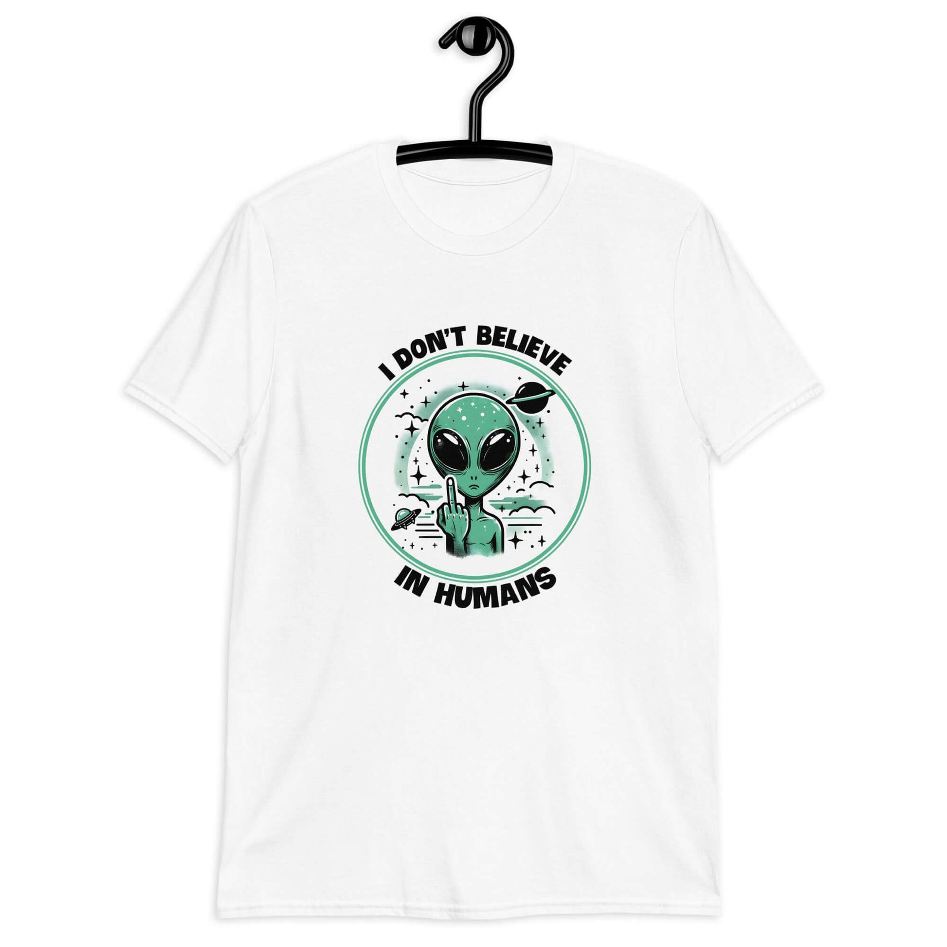 White t-shirt with an image of an alien flipping the middle finger. The words I don't believe in humans are printed around the image. The graphics are printed on the front of the shirt.