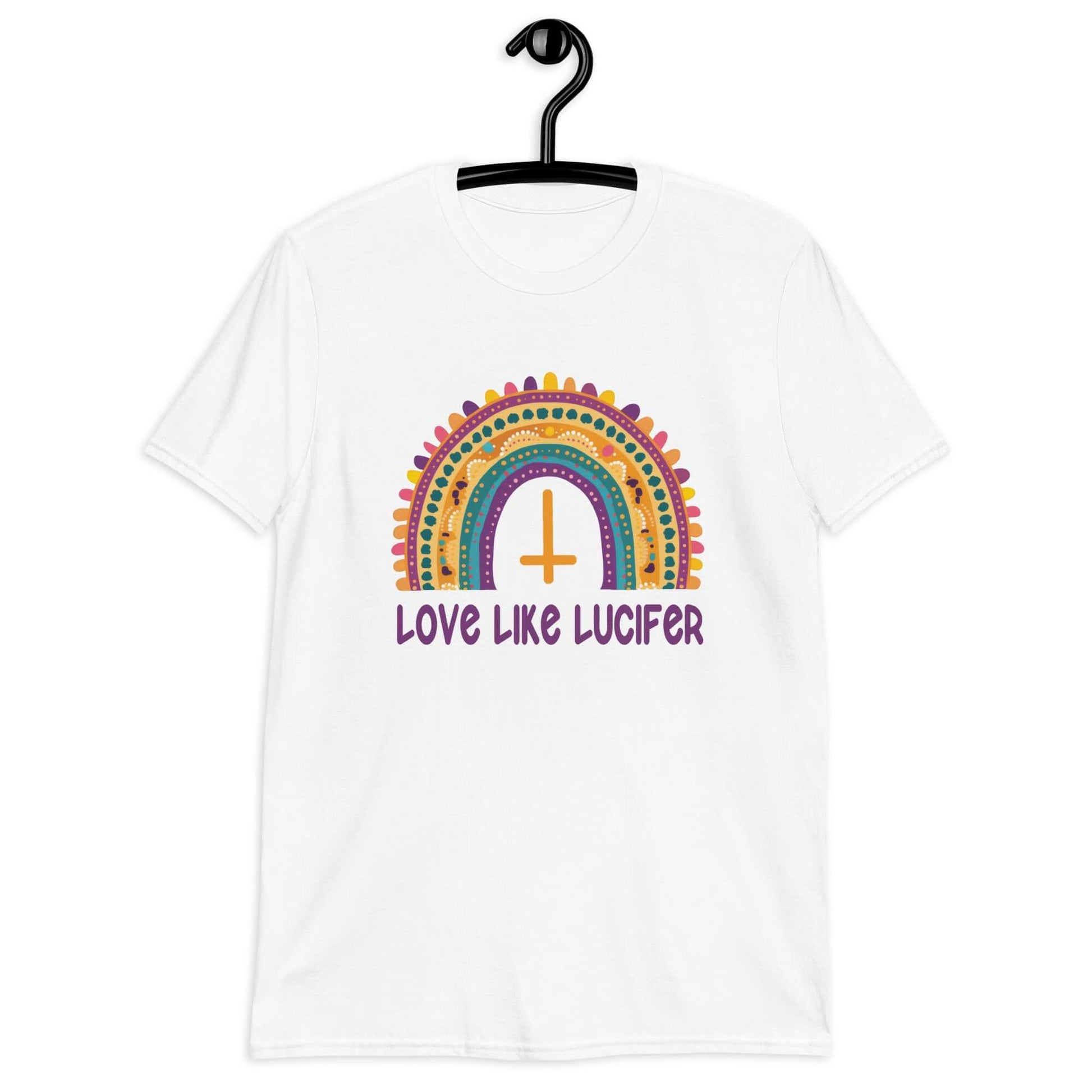 White t-shirt with an image of a boho style rainbow. There is an upside down cross in the center arch of the rainbow and the phrase Love like Lucifer printed under. The graphics are printed on the front.