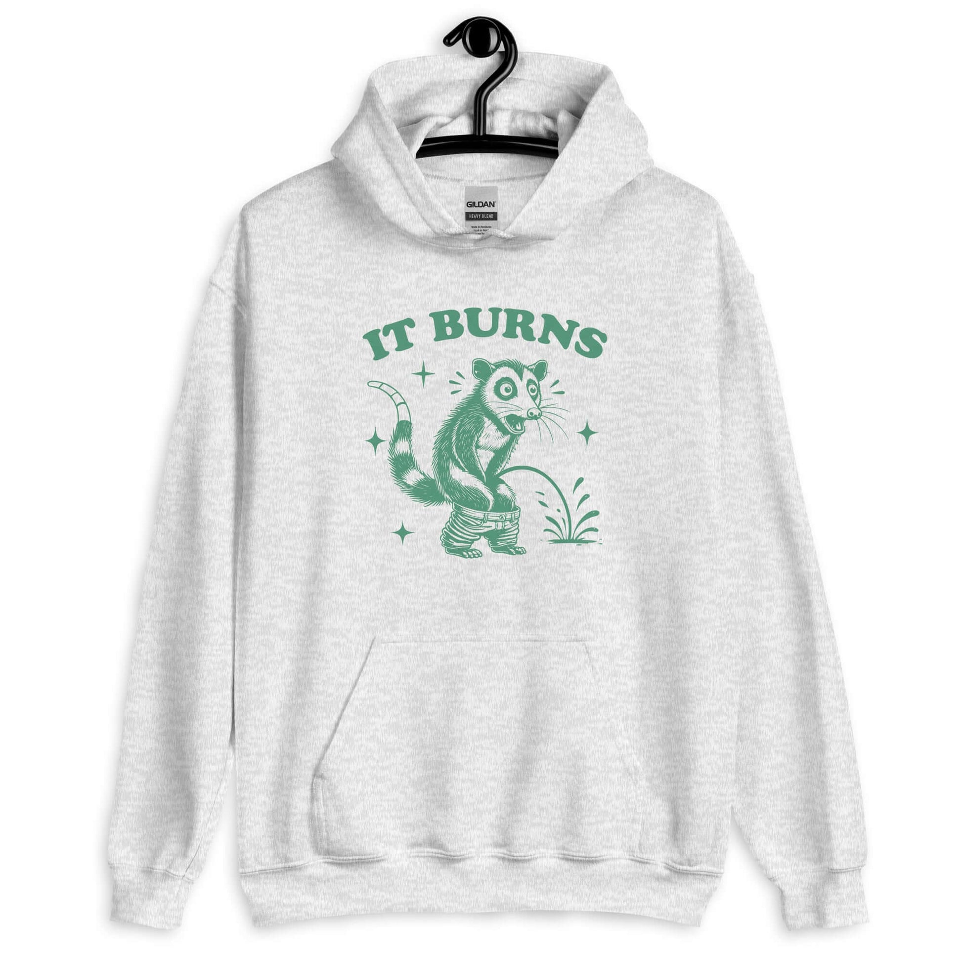 Ash color hoodie sweatshirt with an image of an opossum peeing. The words It burns are printed above.