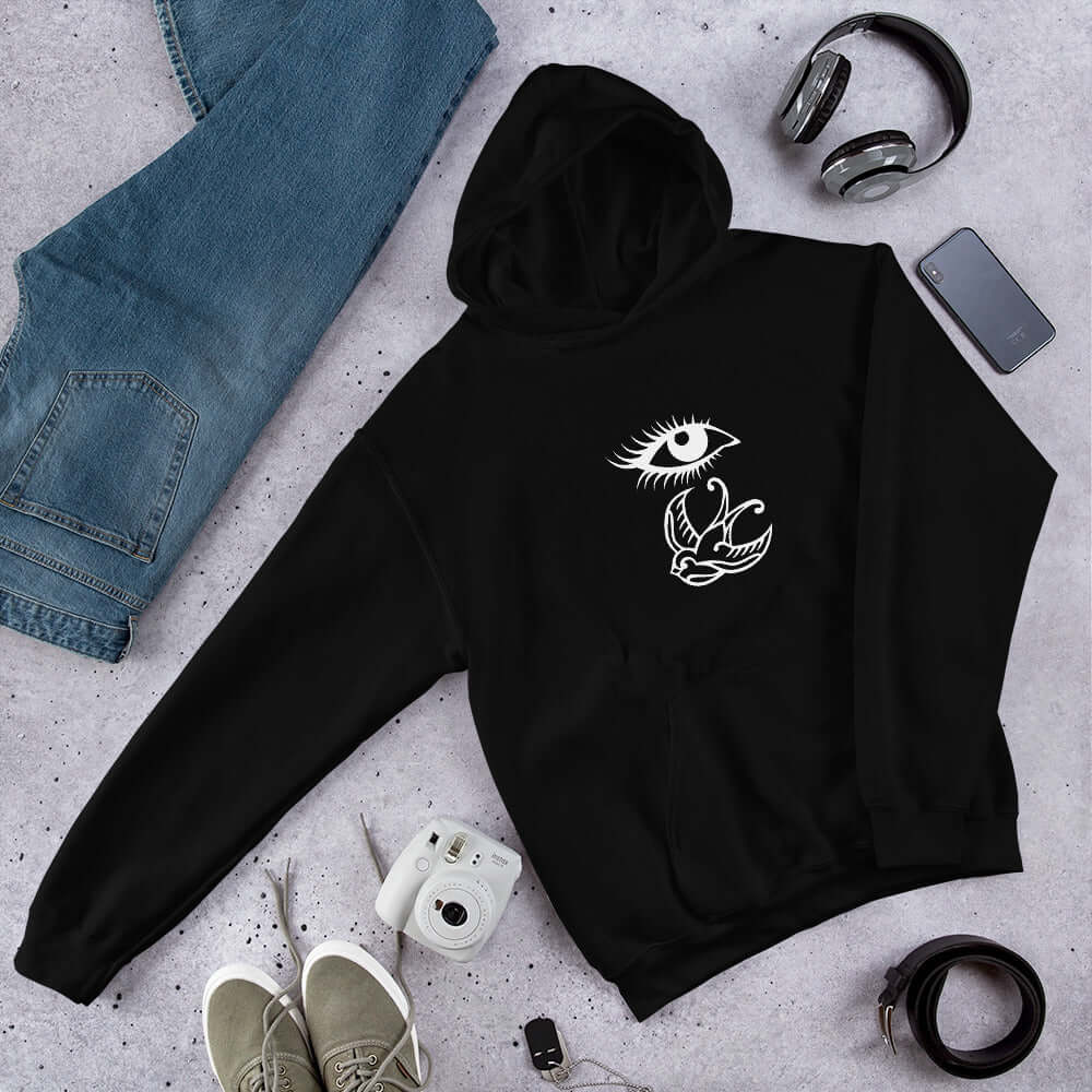 Black hoodie sweatshirt with outline drawing of an eye and a swallow bird printed on the front.