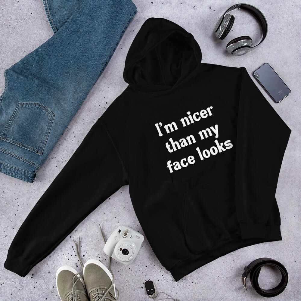 White hoodie sweatshirt that says I'm nicer than my face looks printed on the front.