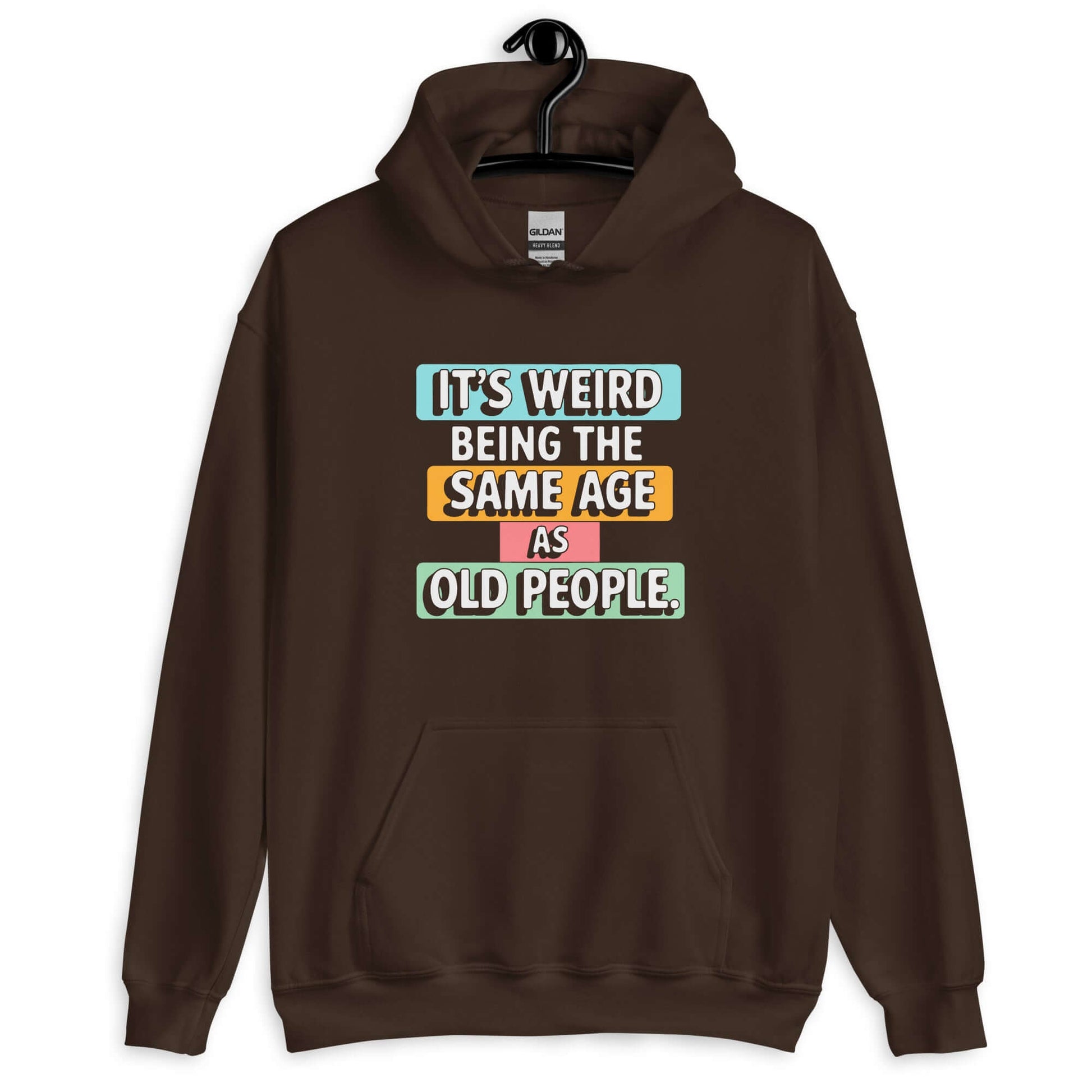 Dark brown hoodie sweatshirt with colorful graphics that say It's weird being the same age as old people printed on the front.