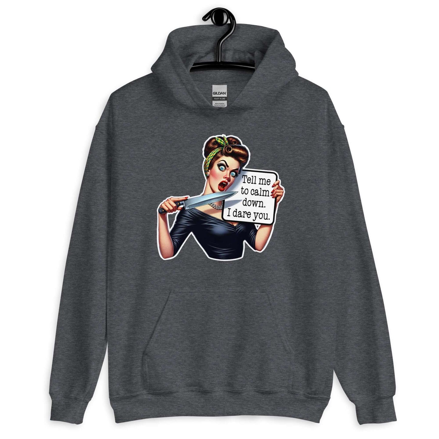 Dark grey hooded sweatshirt displayed on a hanger. The sweatshirt has a graphic of an angry looking retro woman holding a knife and a sign. The sign says Tell me to calm down I dare you. The graphic is printed on the front of the hoodie.