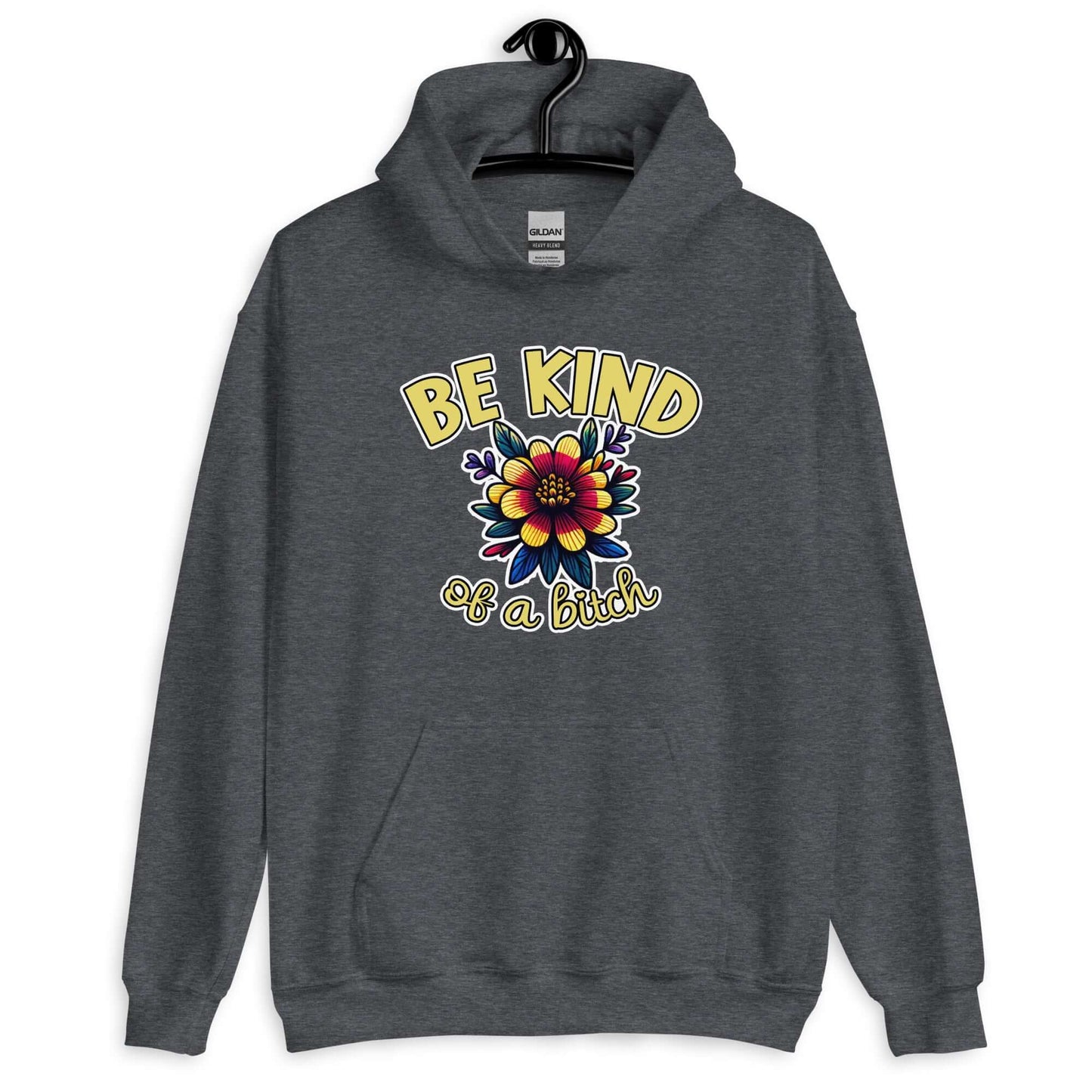 Dark heather grey hoodie sweatshirt with an image of a flower and the words Be kind above the flower in yellow bold block font. The words Of a bitch are smaller in script font under the flower. The design is printed on the front of the hoodie.