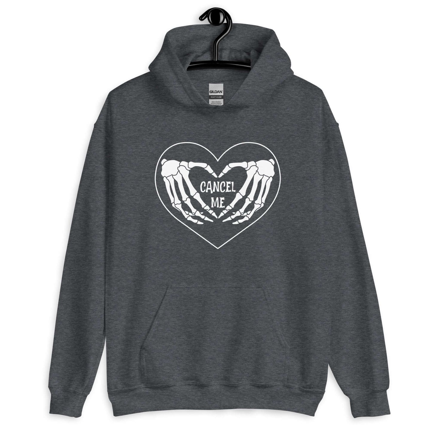 Dark heather grey hoodie sweatshirt with a black heart and skeleton hands making a heart shape printed on the front. The words Cancel Me are inside of the heart.