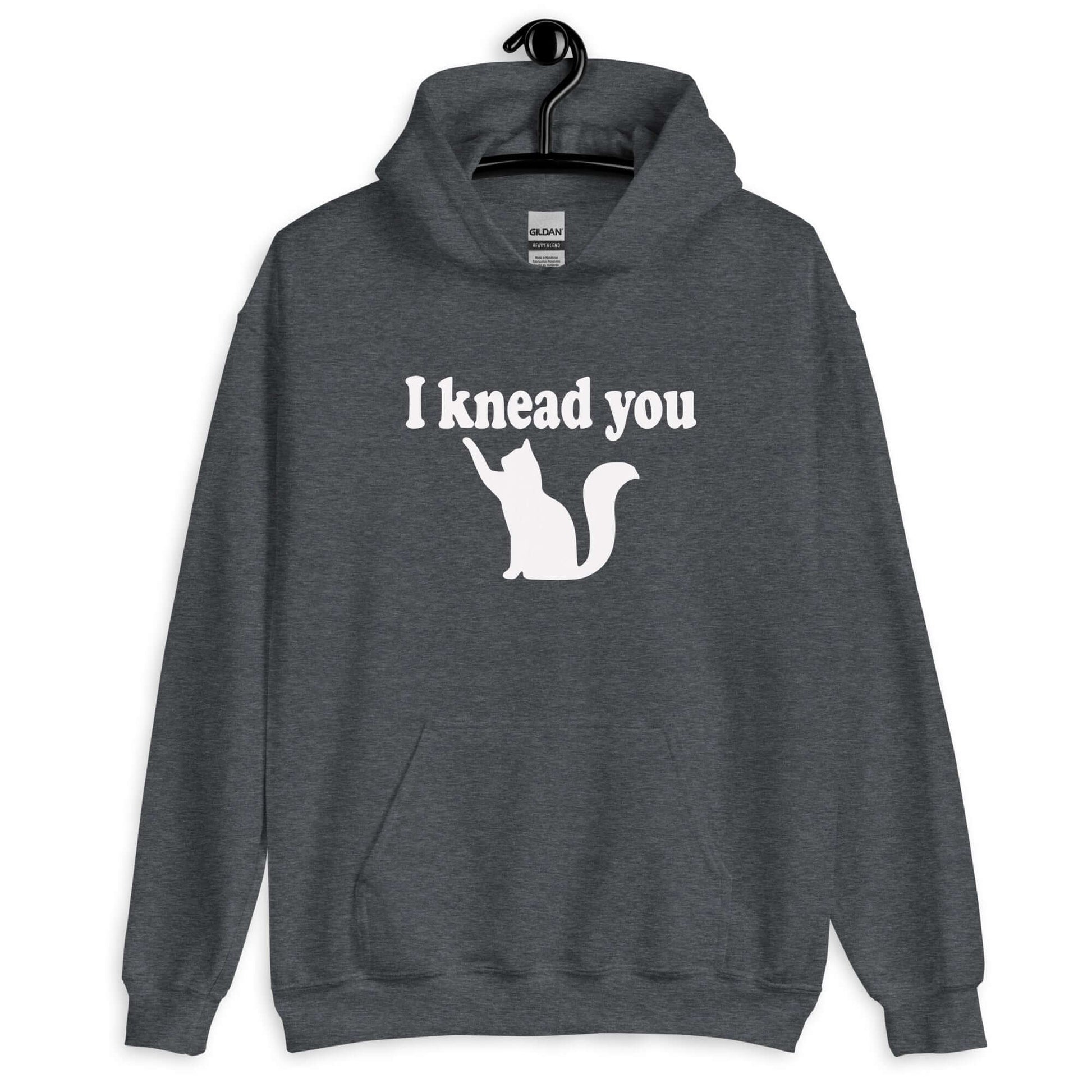 Dark heather hoodie sweatshirt that has an image of a silhouette of a cat and the words I knead you printed on the front.