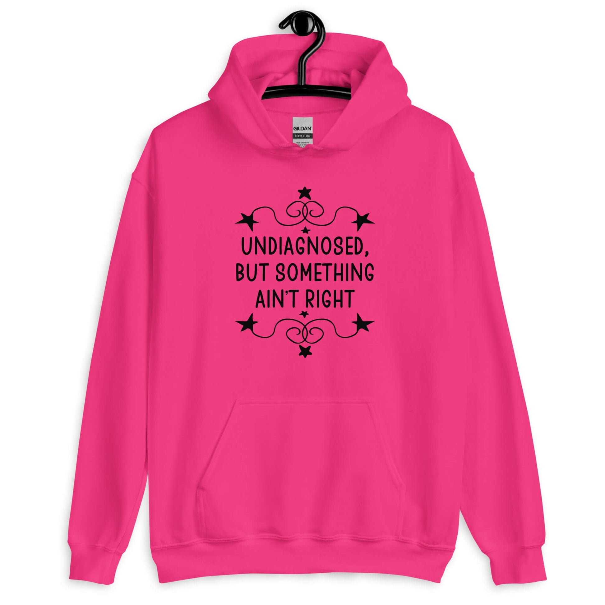 Heliconia pink hoodie sweatshirt with the phrase Undiagnosed, but something ain't right printed on the front. The text is white and has a star graphic embellishment around the words.