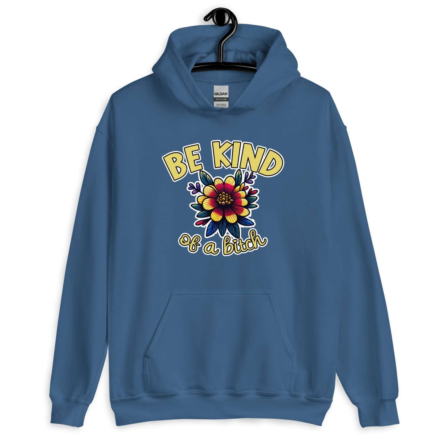 Indigo blue hoodie sweatshirt with an image of a flower and the words Be kind above the flower in yellow bold block font. The words Of a bitch are smaller in script font under the flower. The design is printed on the front of the hoodie.