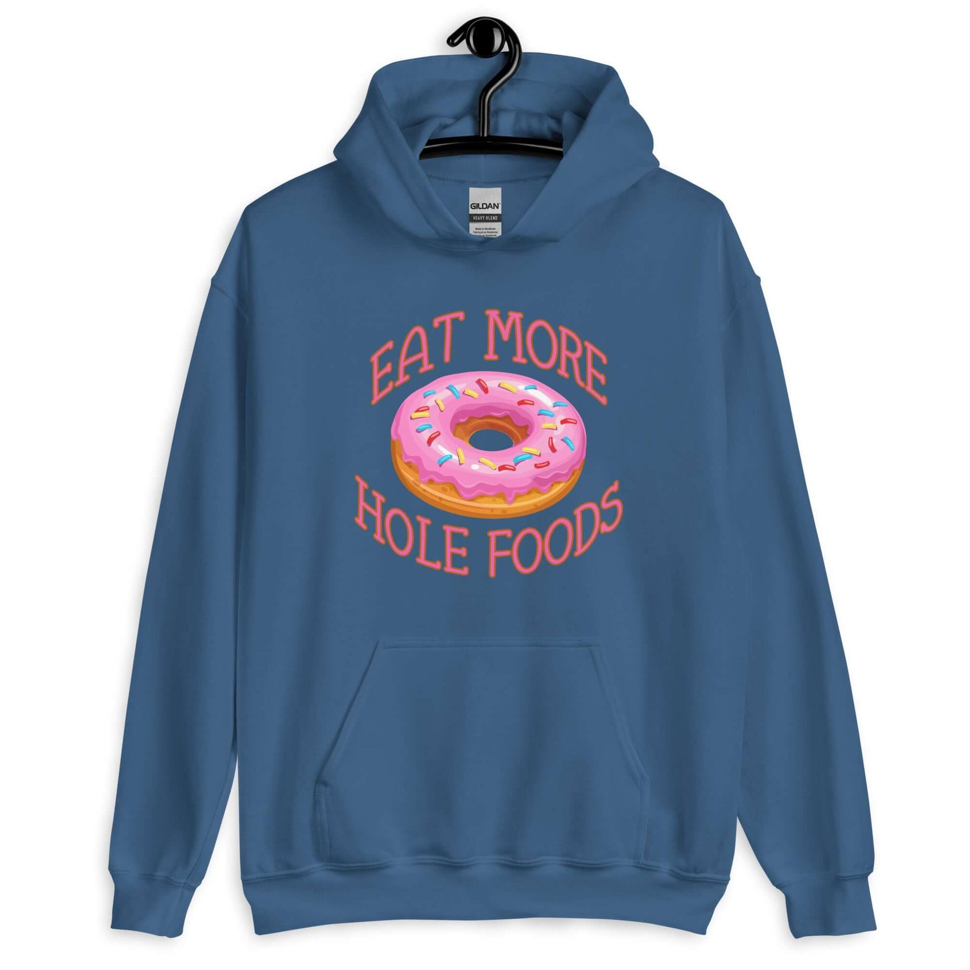 Indigo blue hoodie sweatshirt with an image of a donut with pink icing and sprinkles and the words Eat more hole foods printed on the front.