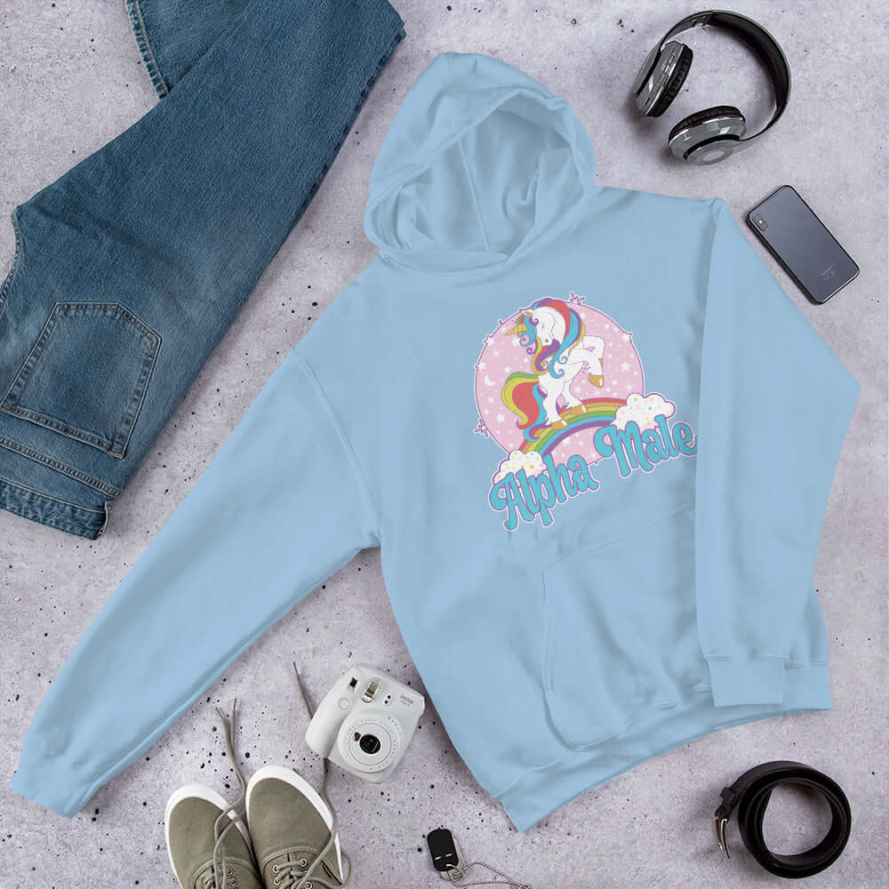 Light blue hoodie sweatshirt with funny pastel rainbow unicorn graphics and the words Alpha Male printed on the front.