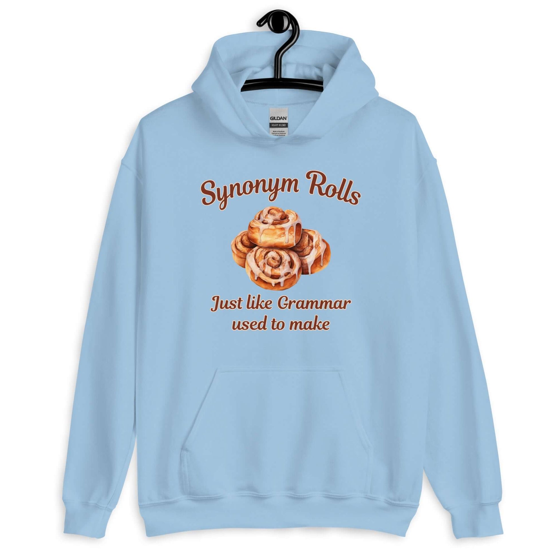 Light blue hoodie sweatshirt with an image of cinnamon rolls and the pun phrase Synonym rolls Just like Grammar used to make printed on the front.