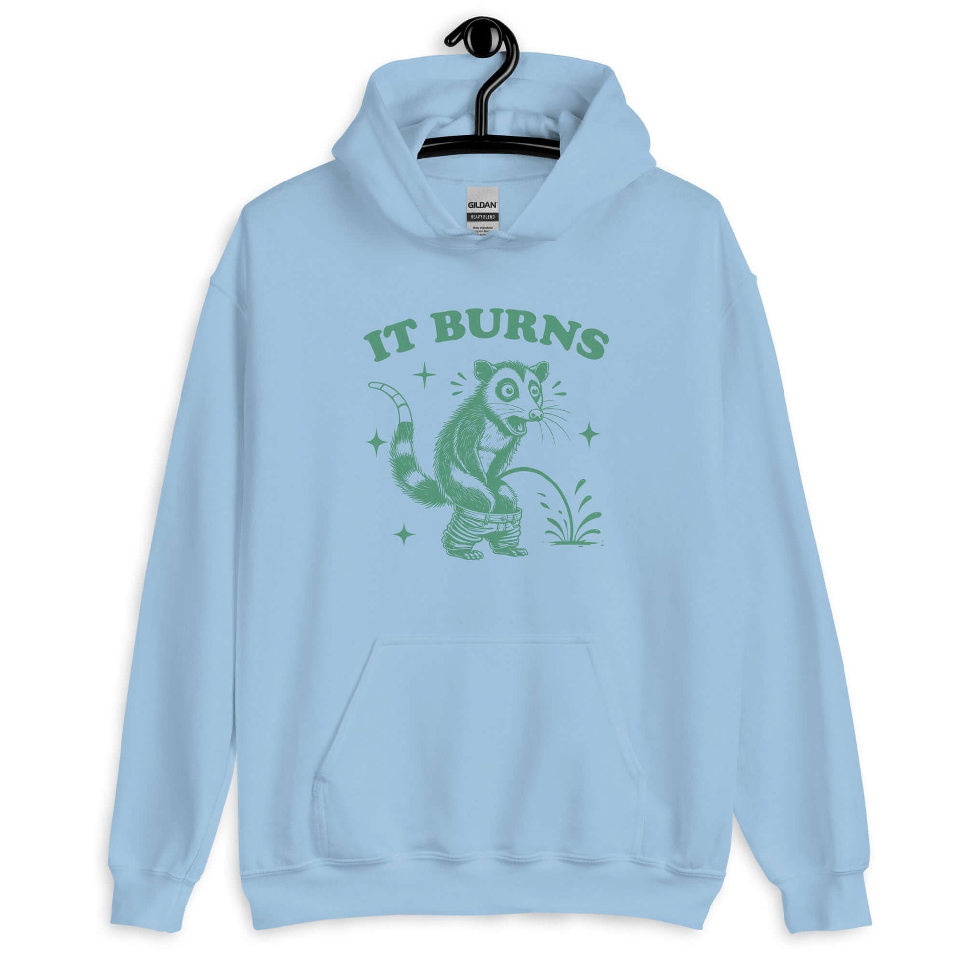 Light blue hoodie sweatshirt with an image of an opossum peeing. The words It burns are printed above.