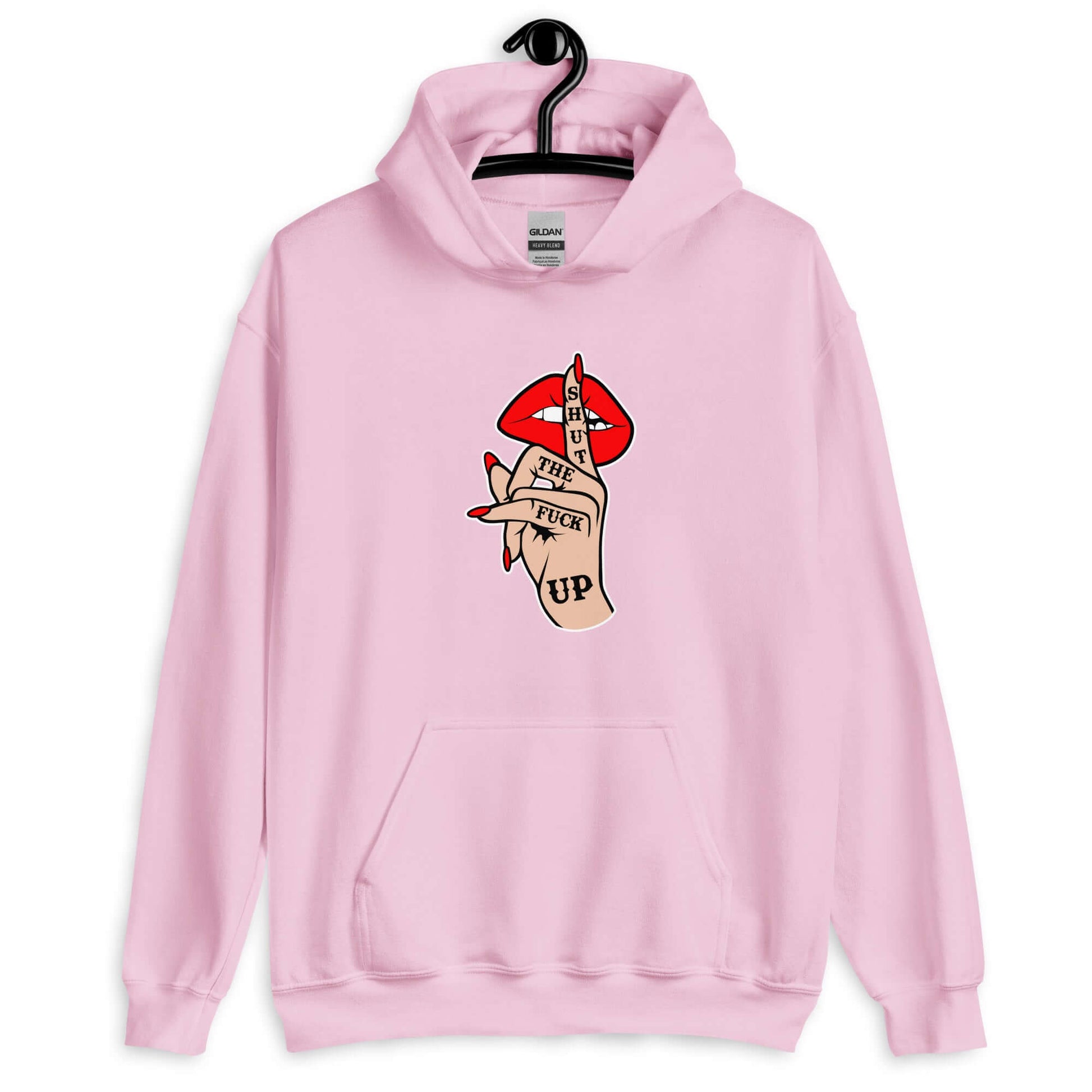 Light pink hoodie sweatshirt with an image of a hand over lips making the shh gesture. The words Shut the fuck up are printed on the hand. The graphics are printed on the front of the hoodie.