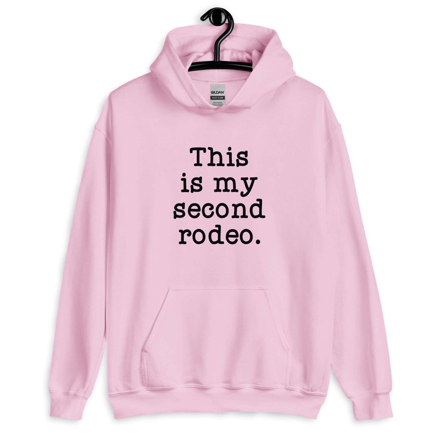 Light pink hoodie sweatshirt with the funny phrase This is my second rodeo printed on the front.