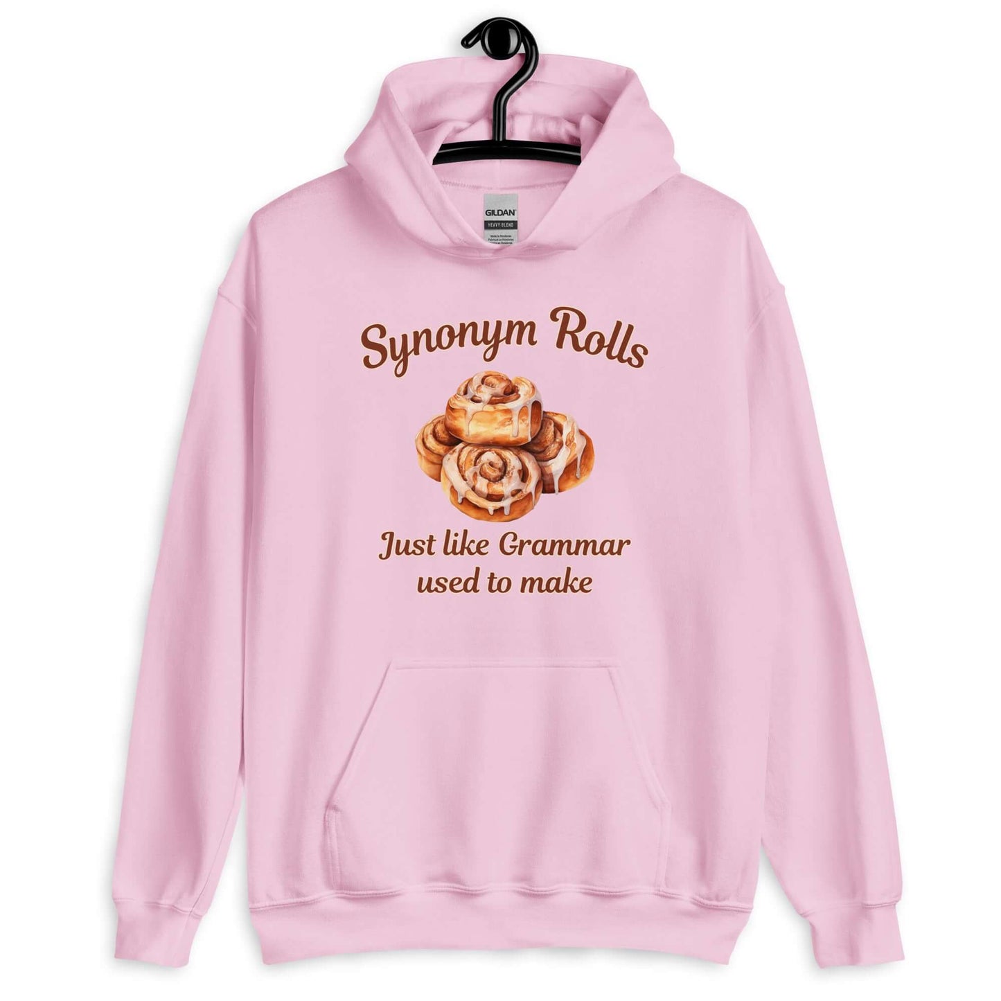 Light pink hoodie sweatshirt with an image of cinnamon rolls and the pun phrase Synonym rolls Just like Grammar used to make printed on the front.