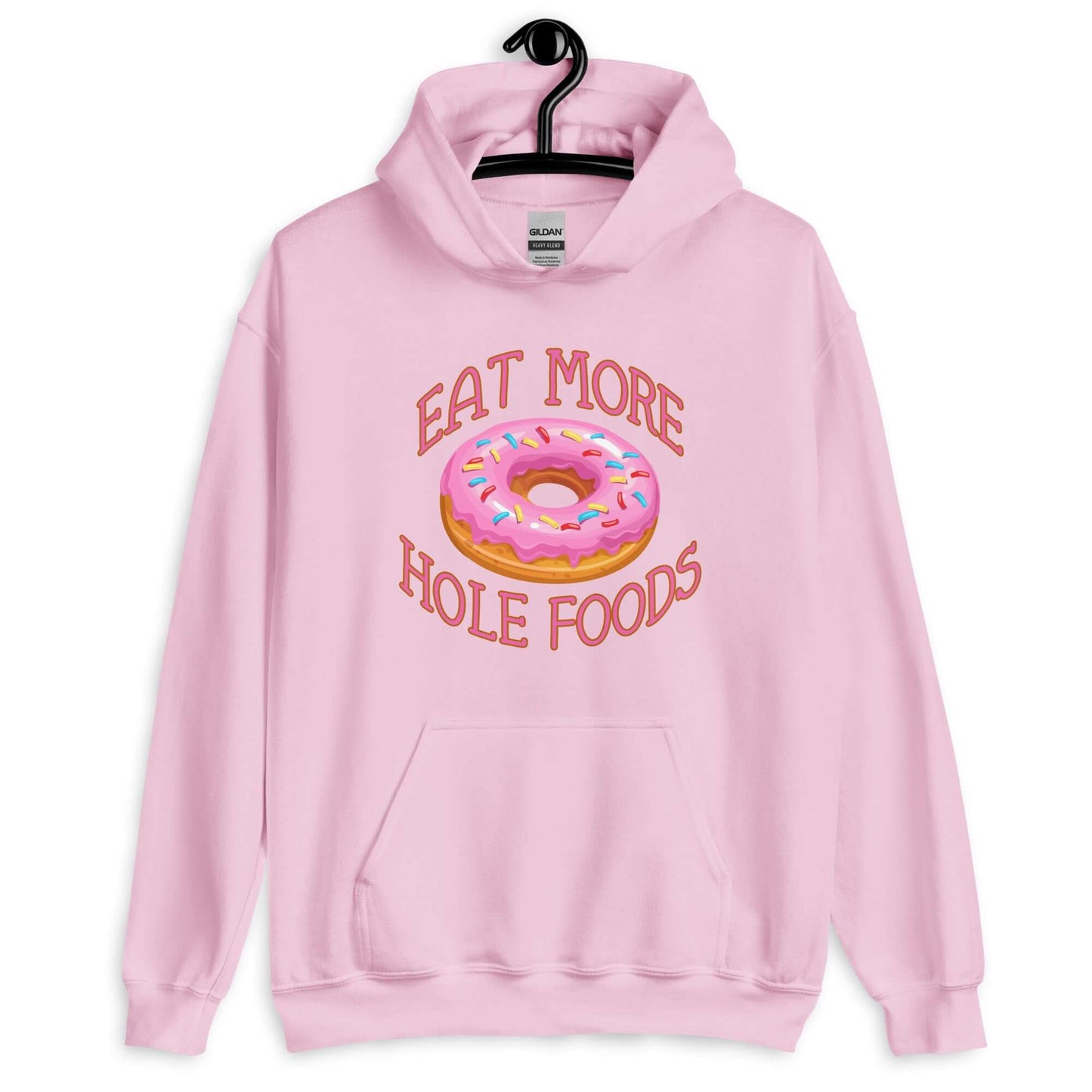 Light pink hoodie sweatshirt with an image of a donut with pink icing and sprinkles and the words Eat more hole foods printed on the front.