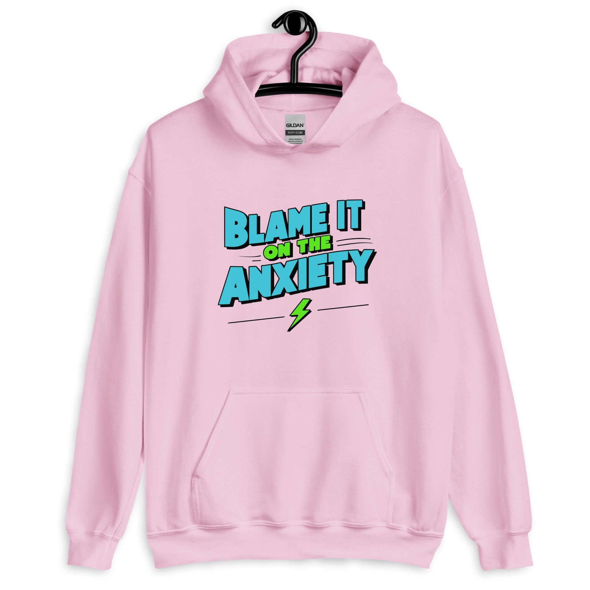 Light pink hoodie sweatshirt with the phrase Blame is on the anxiety printed on the front. The graphics are bold and in aqua and lime green.