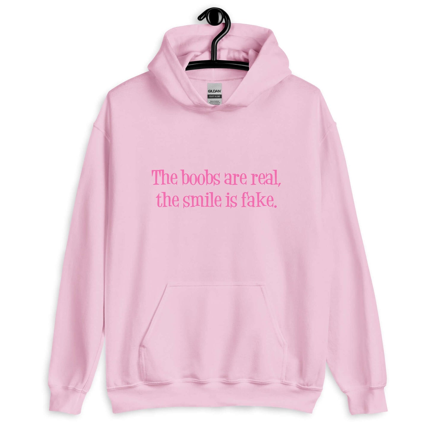 Light pink hoodie sweatshirt with the phrase The boobs are real, the smile is fake printed in pink on the front.