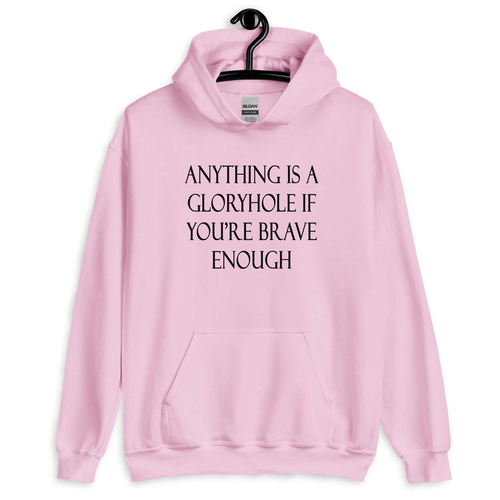 Light pink hoodie sweatshirt with the phrase Anything is a gloryhole if you're brave enough printed on the front.