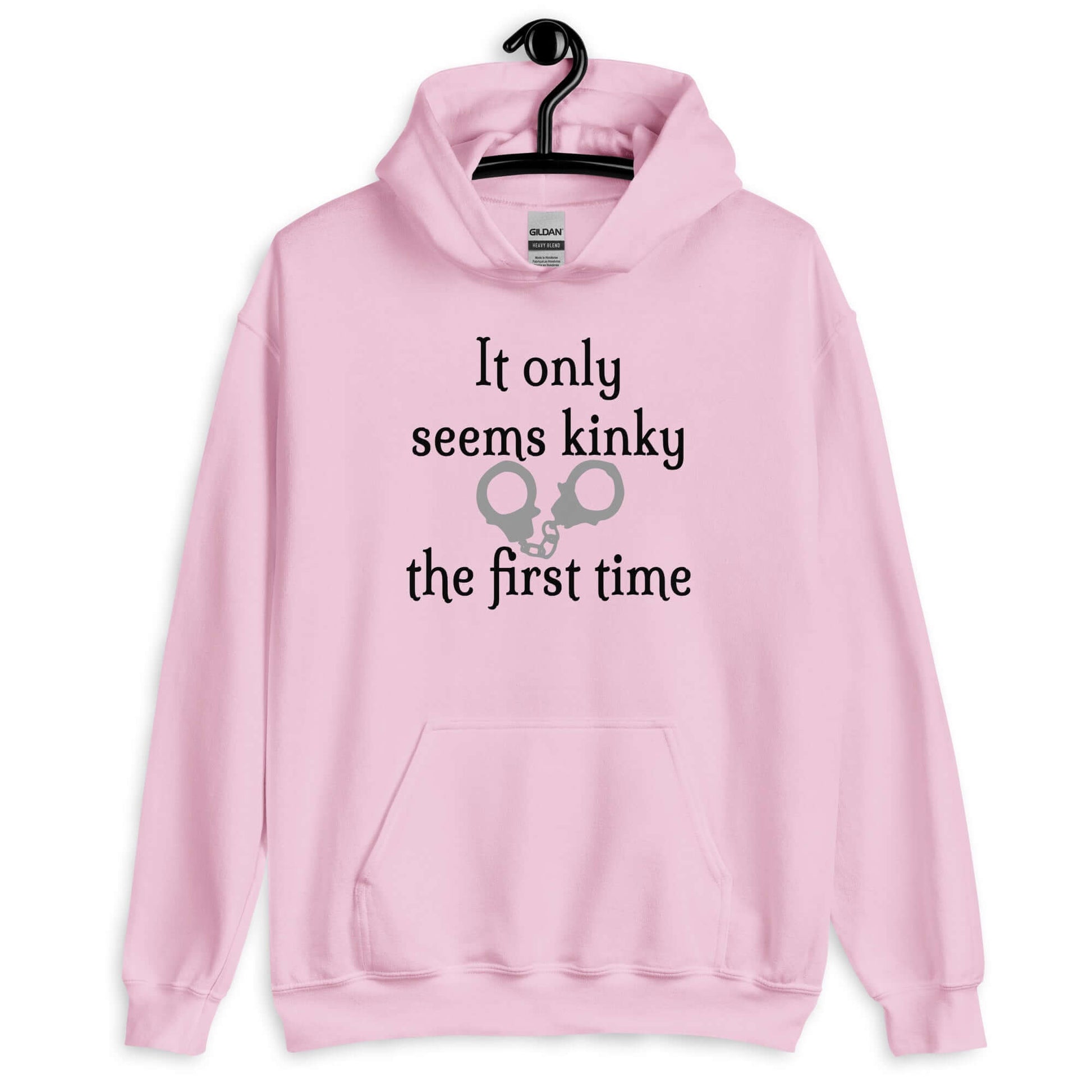 Light pink hoodie sweatshirt with the phrase It only seems kinky the first time printed on the front. There is an image of handcuffs with the text.