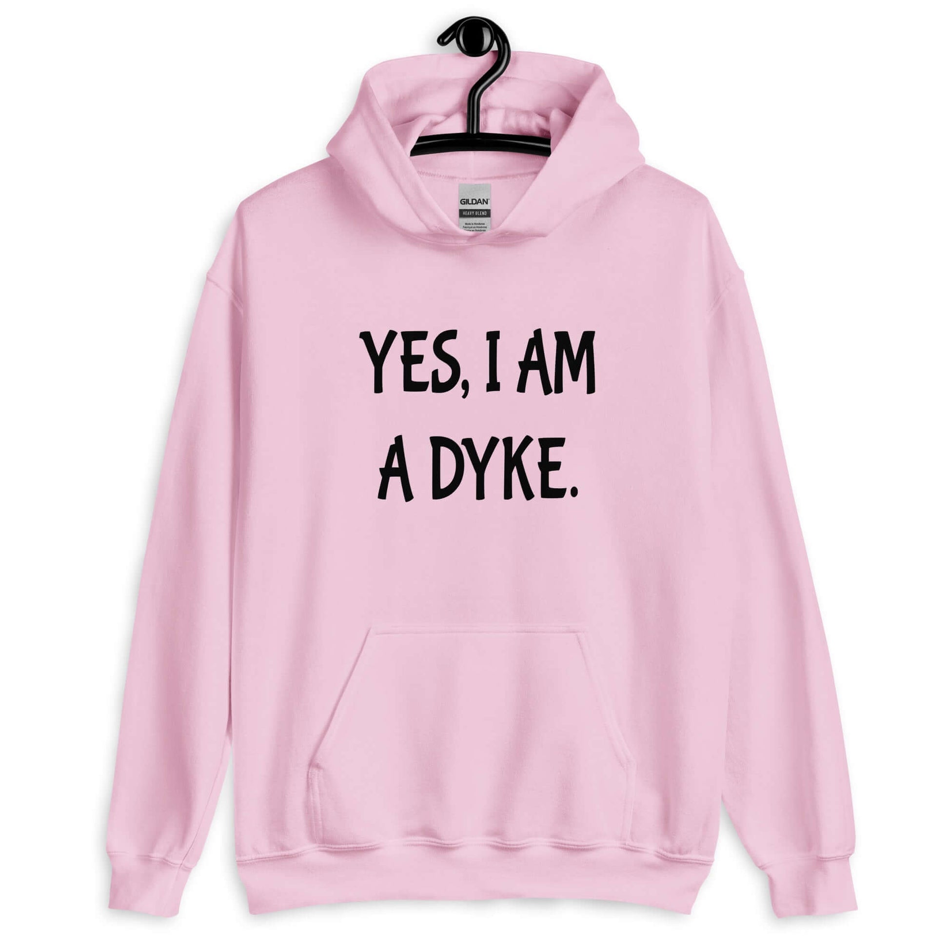 Light pink hoodie sweatshirt with the phrase Yes, I am a dyke printed on the front.