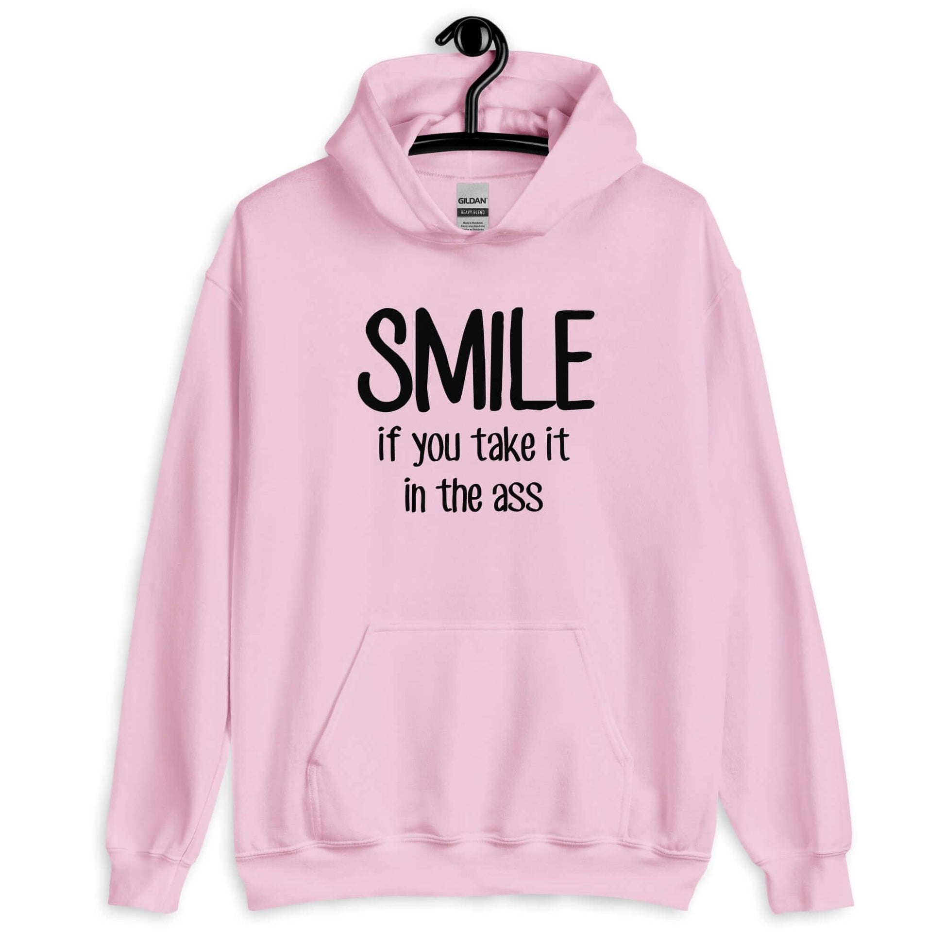 Light pink hoodie sweatshirt with the phrase Smile if you take it in the ass printed on the front. The word smile is large and the words take it in the ass are much smaller.