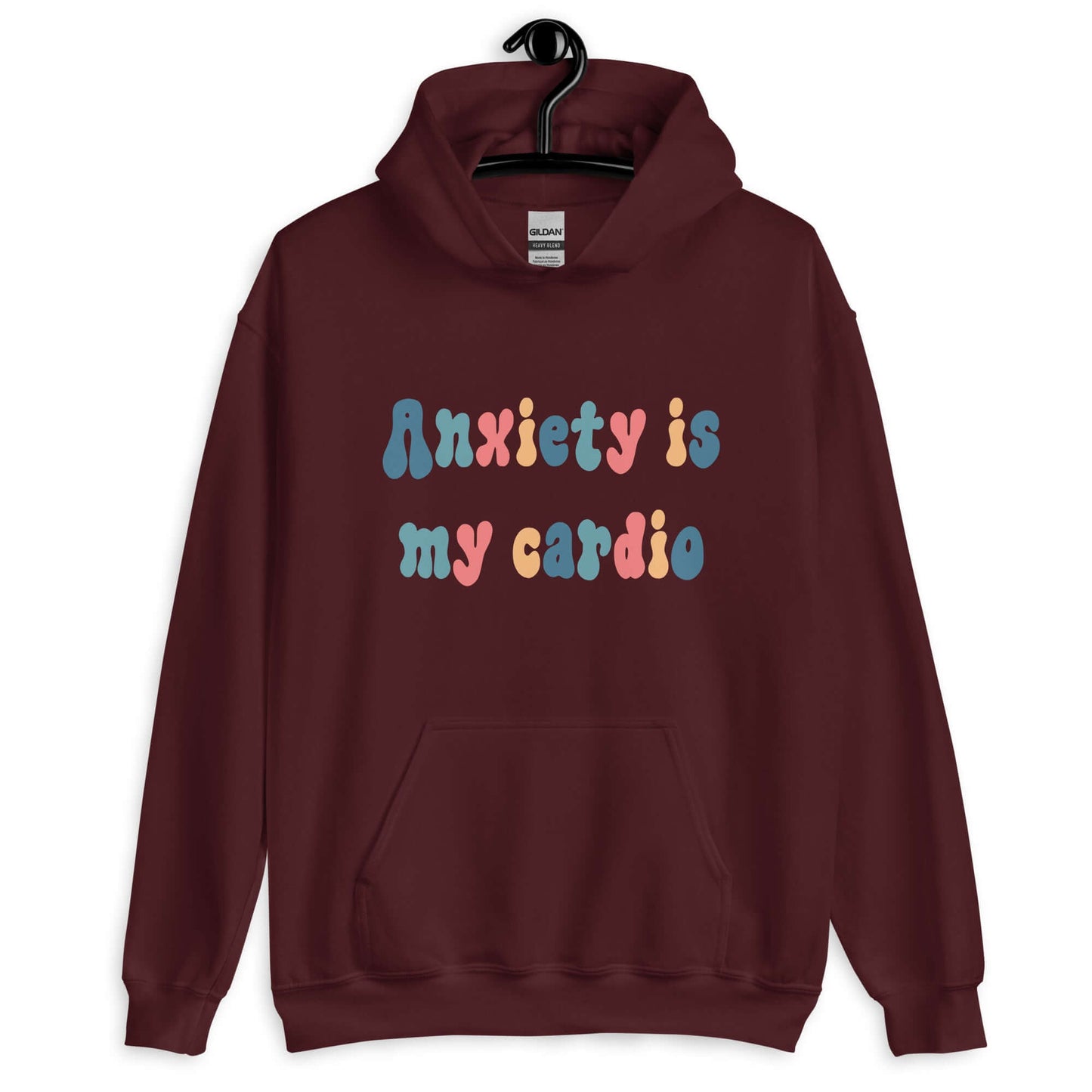 Maroon hoodie sweatshirt with the phrase Anxiety is my cardio printed in multiple colors on the front of the hoodie.