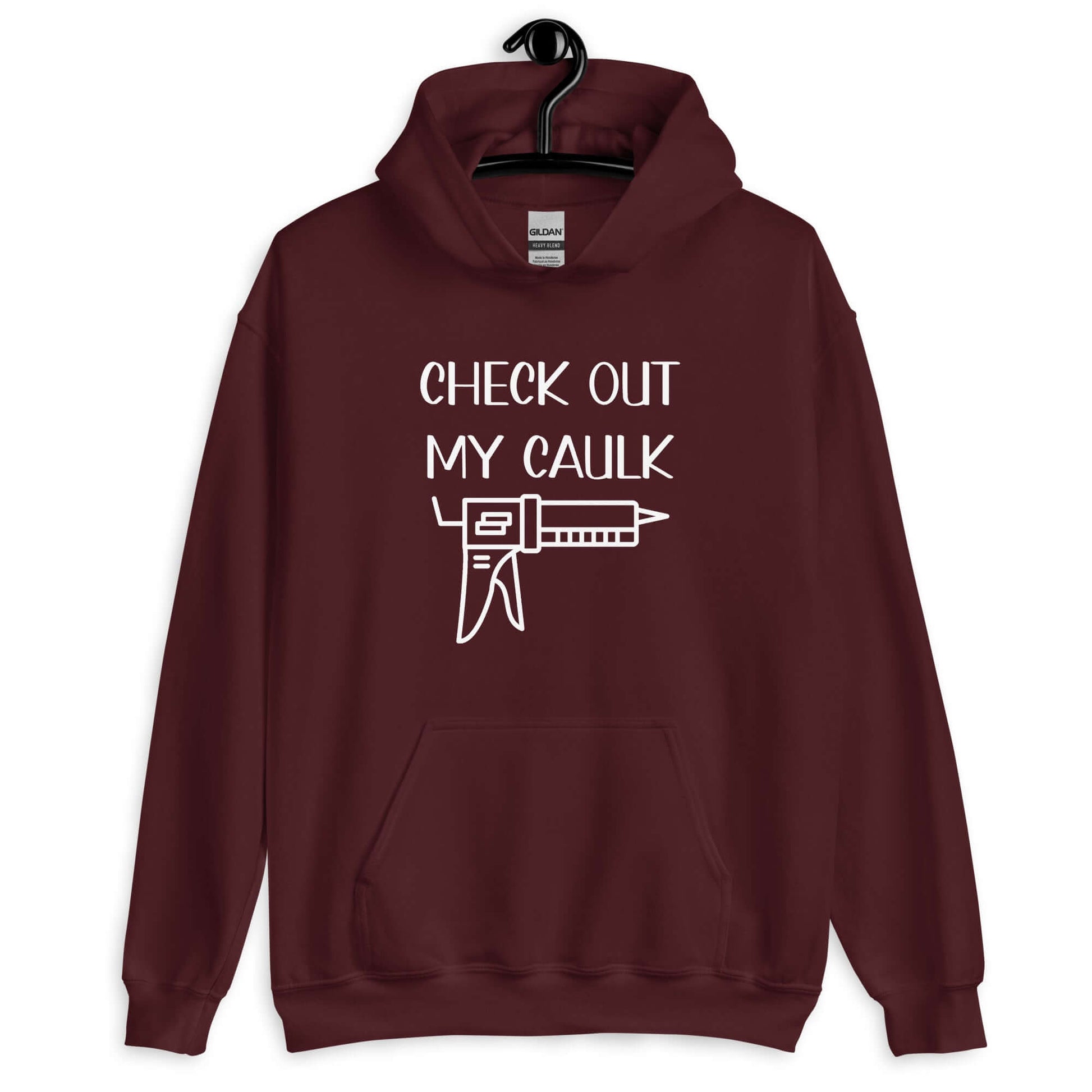 Maroon hoodie sweatshirt with the pun phrase Check out my caulk with a line drawing image of a caulking gun printed on the front.