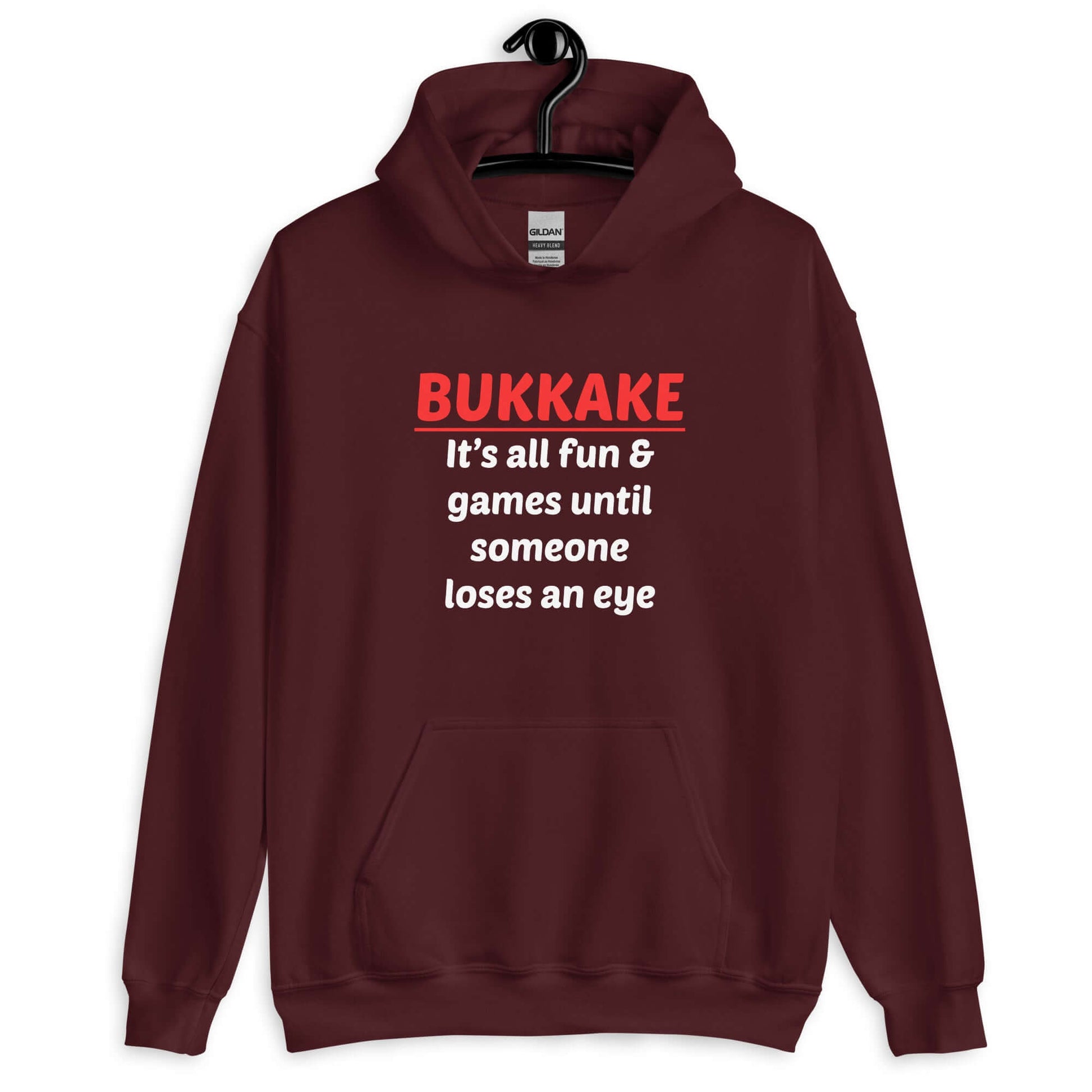 Maroon hoodie sweatshirt with the phrase Bukkake it's all fun & games until someone loses an eye printed on the front.