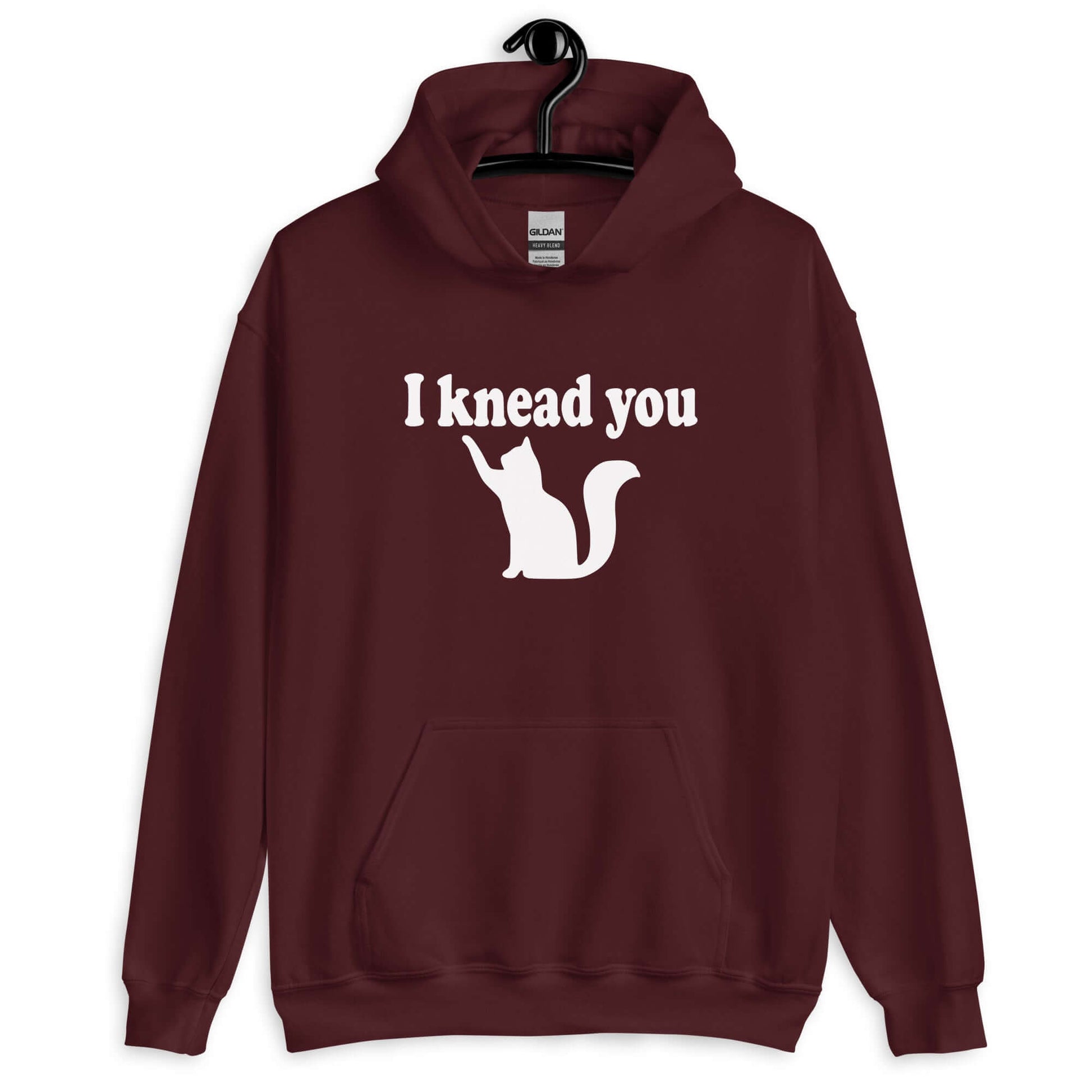 Maroon hoodie sweatshirt that has an image of a silhouette of a cat and the words I knead you printed on the front.