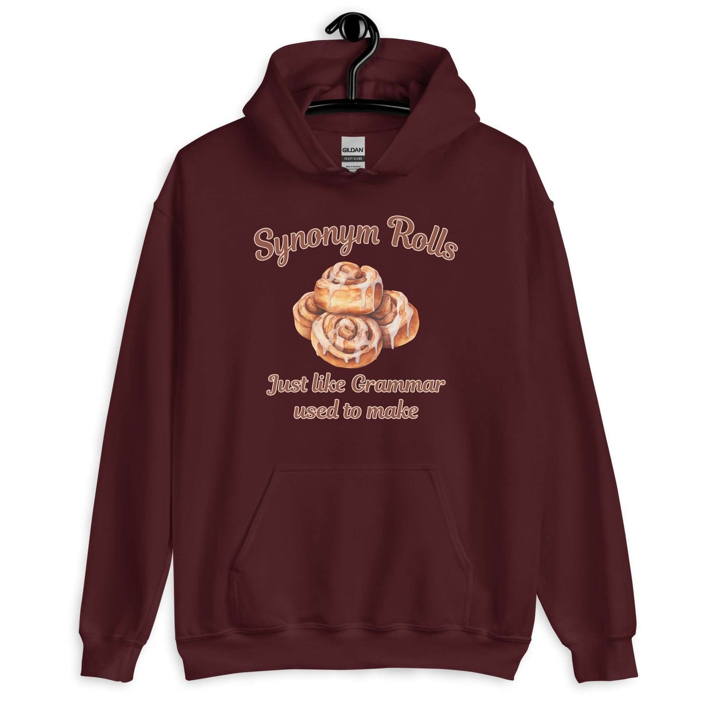 Maroon hoodie sweatshirt with an image of cinnamon rolls and the pun phrase Synonym rolls Just like Grammar used to make printed on the front.