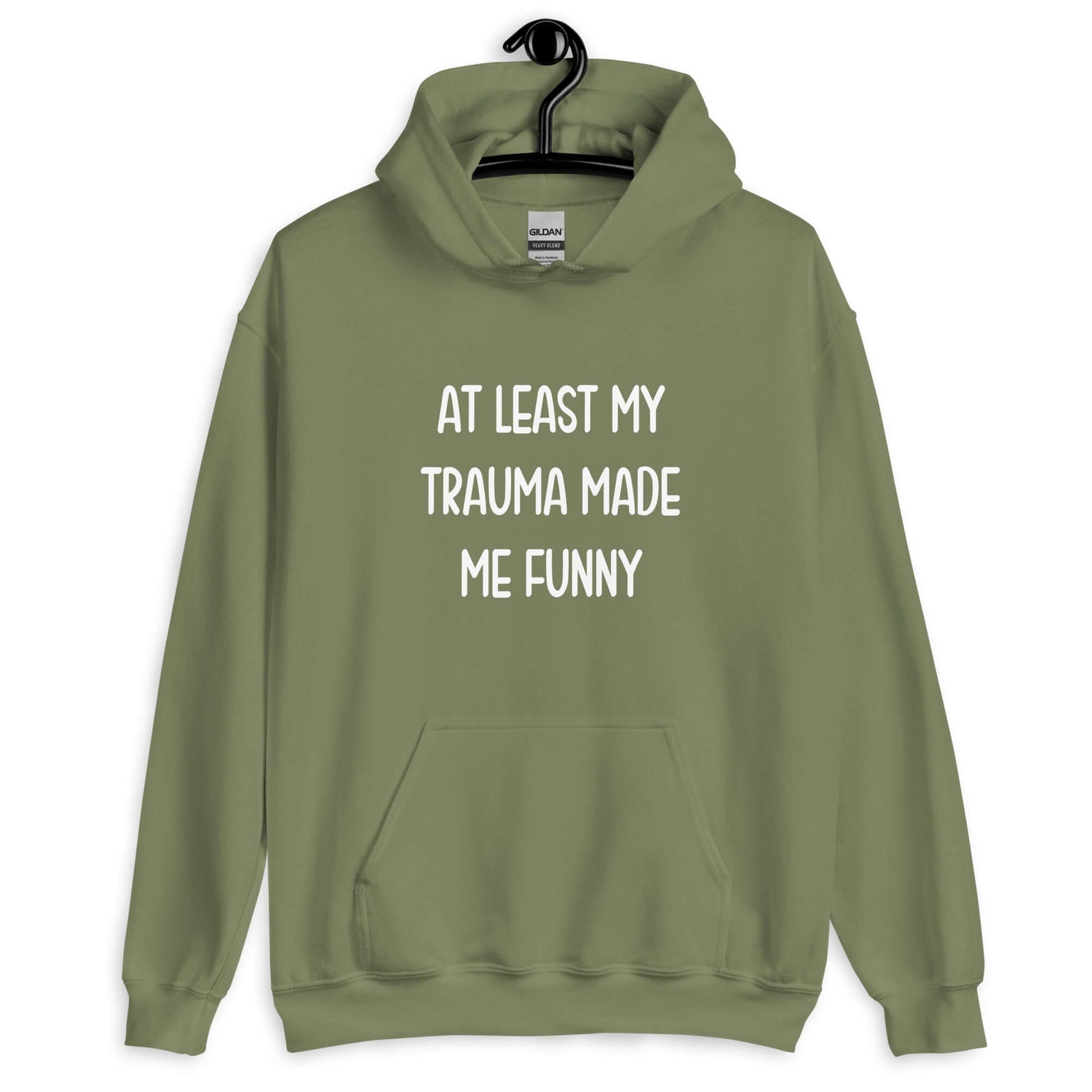 Military green hoodie sweatshirt with the words At least my trauma made me funny printed on the front.