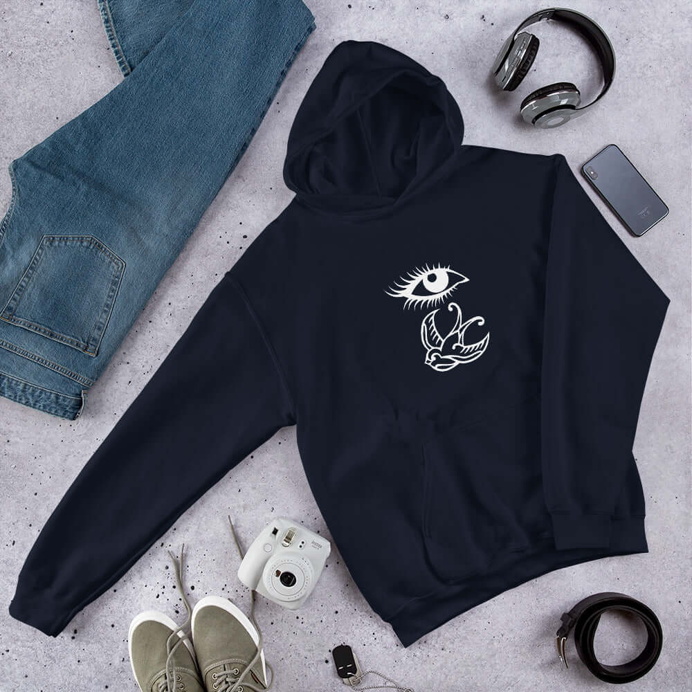 Navy blue hoodie sweatshirt with outline drawing of an eye and a swallow bird printed on the front.