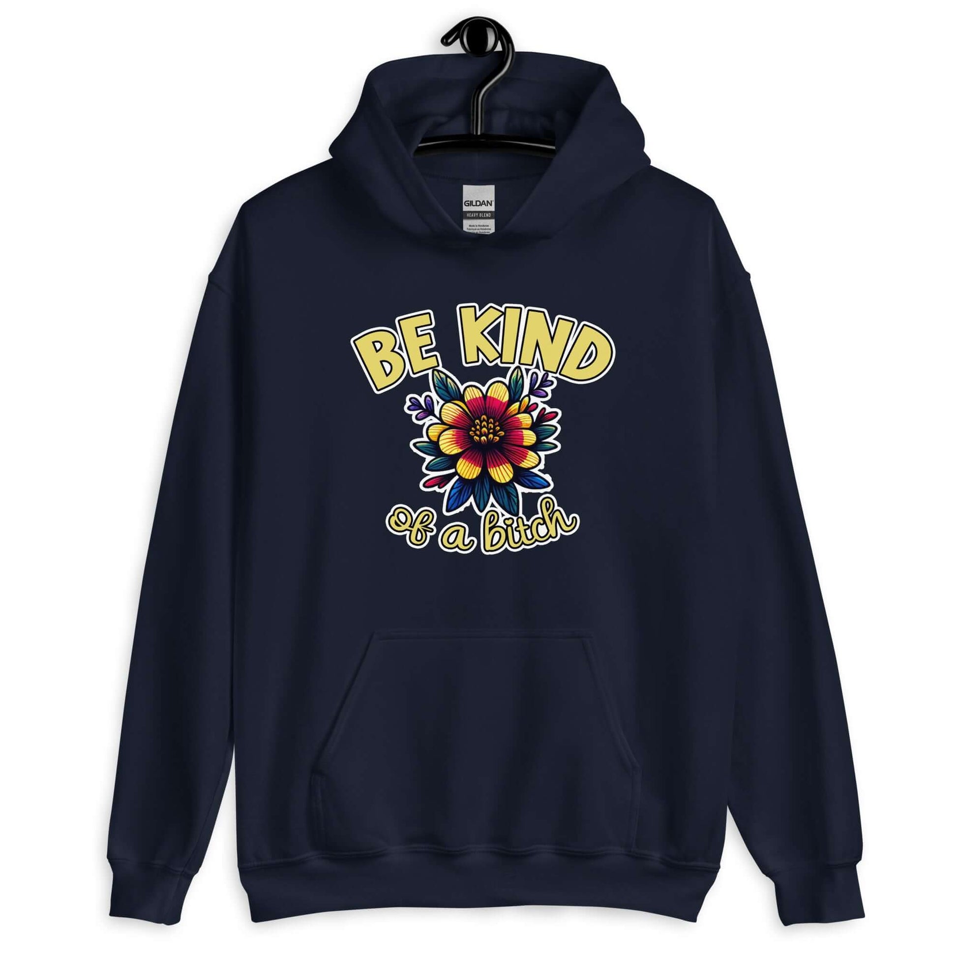 Navy blue hoodie sweatshirt with an image of a flower and the words Be kind above the flower in yellow bold block font. The words Of a bitch are smaller in script font under the flower. The design is printed on the front of the hoodie.