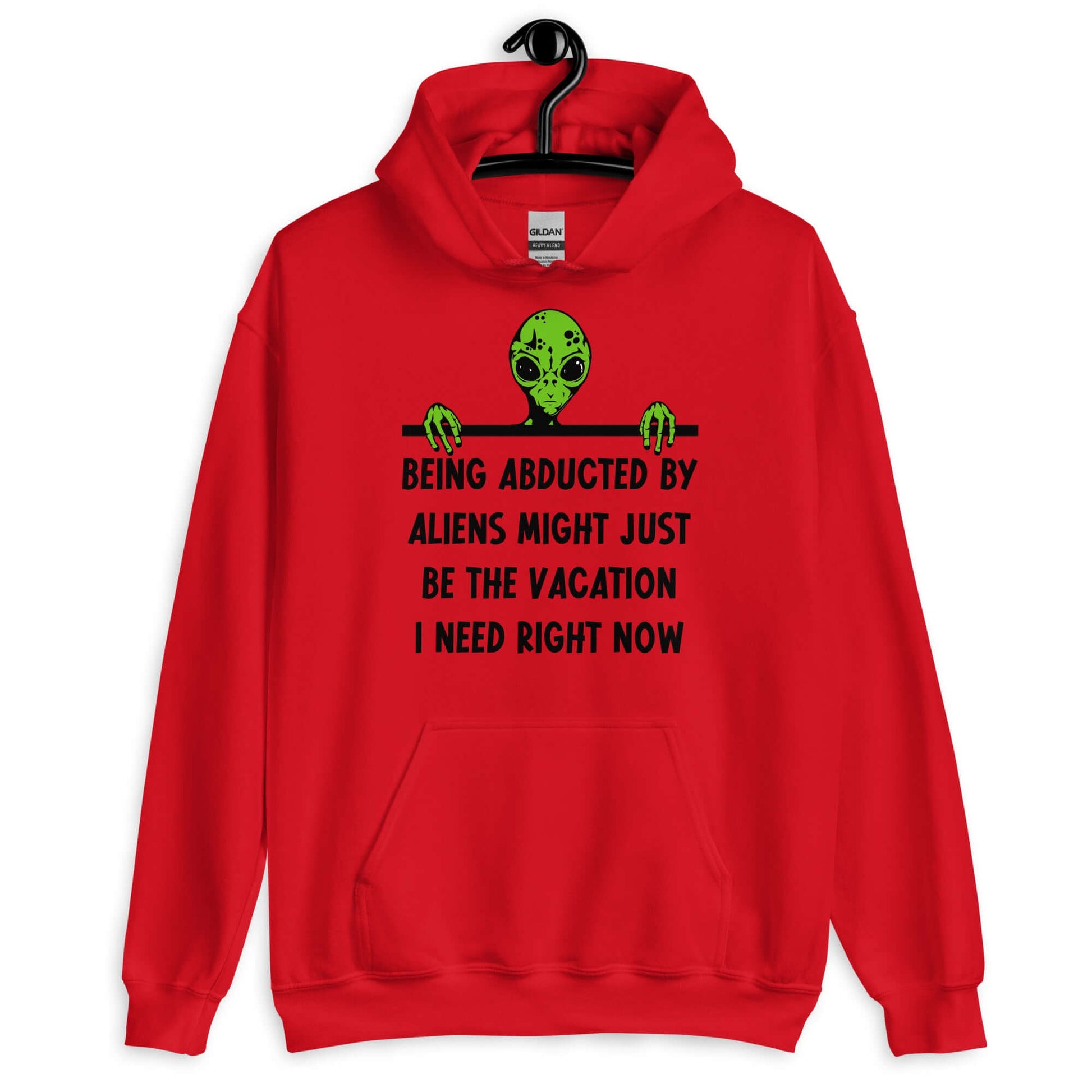Red hoodie with an image of a green alien and the phrase Being abducted by aliens might just be the vacation I need right now printed on the front of the sweatshirt.