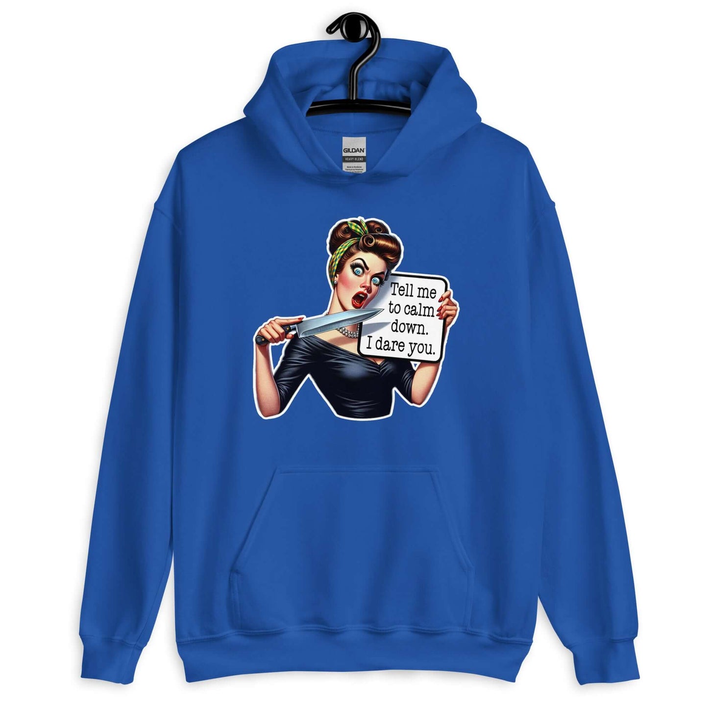 Royal blue hooded sweatshirt displayed on a hanger. The sweatshirt has a graphic of an angry looking retro woman holding a knife and a sign. The sign says Tell me to calm down I dare you. The graphic is printed on the front of the hoodie.